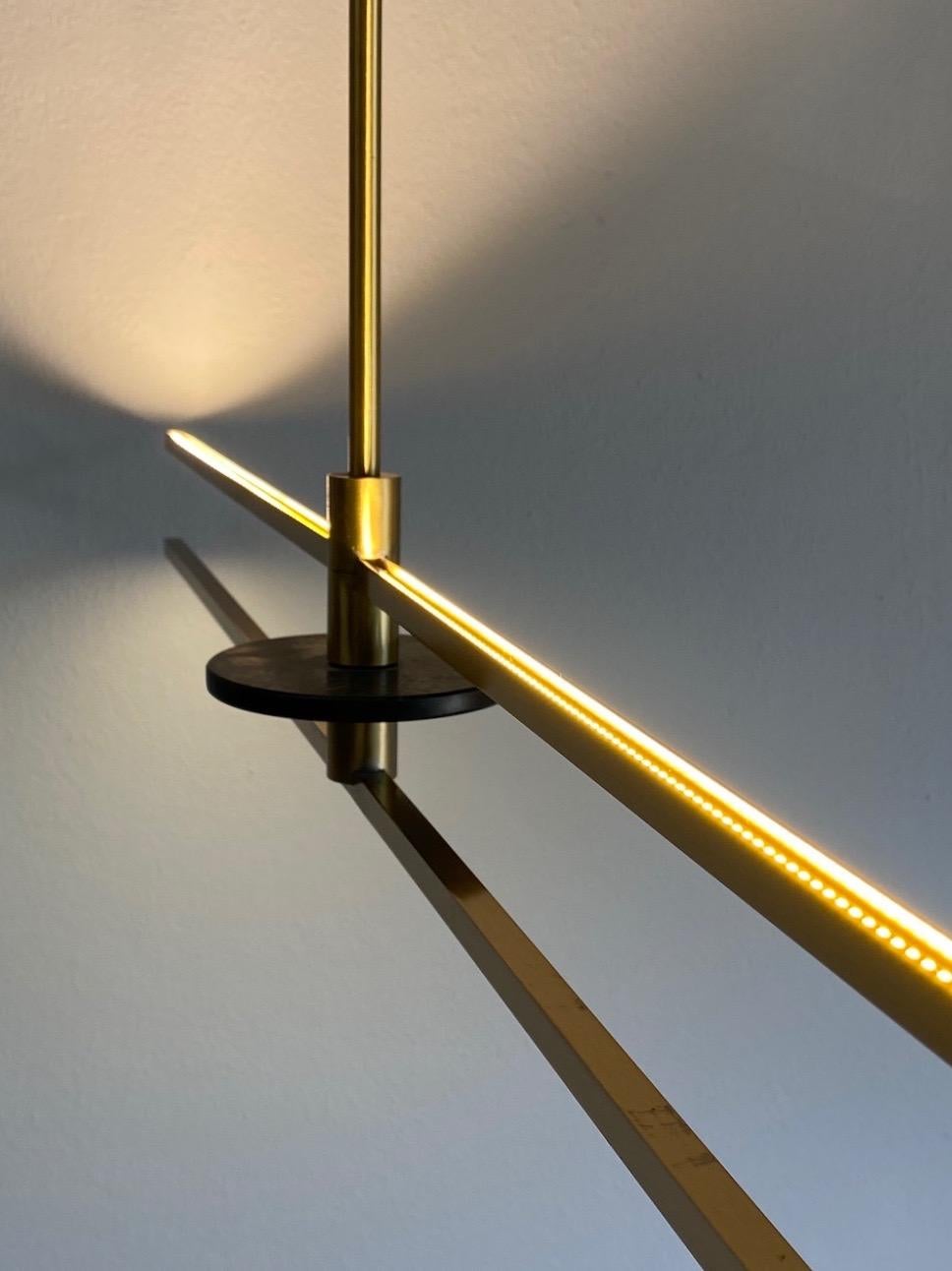 Cosulich Interiors in collaboration with Matlight Studio: this contemporary organic modern lighting, entirely handcrafted in Italy, is part of a collection called essential stick, the core and canopy are here decorated with Nero Marquina marble