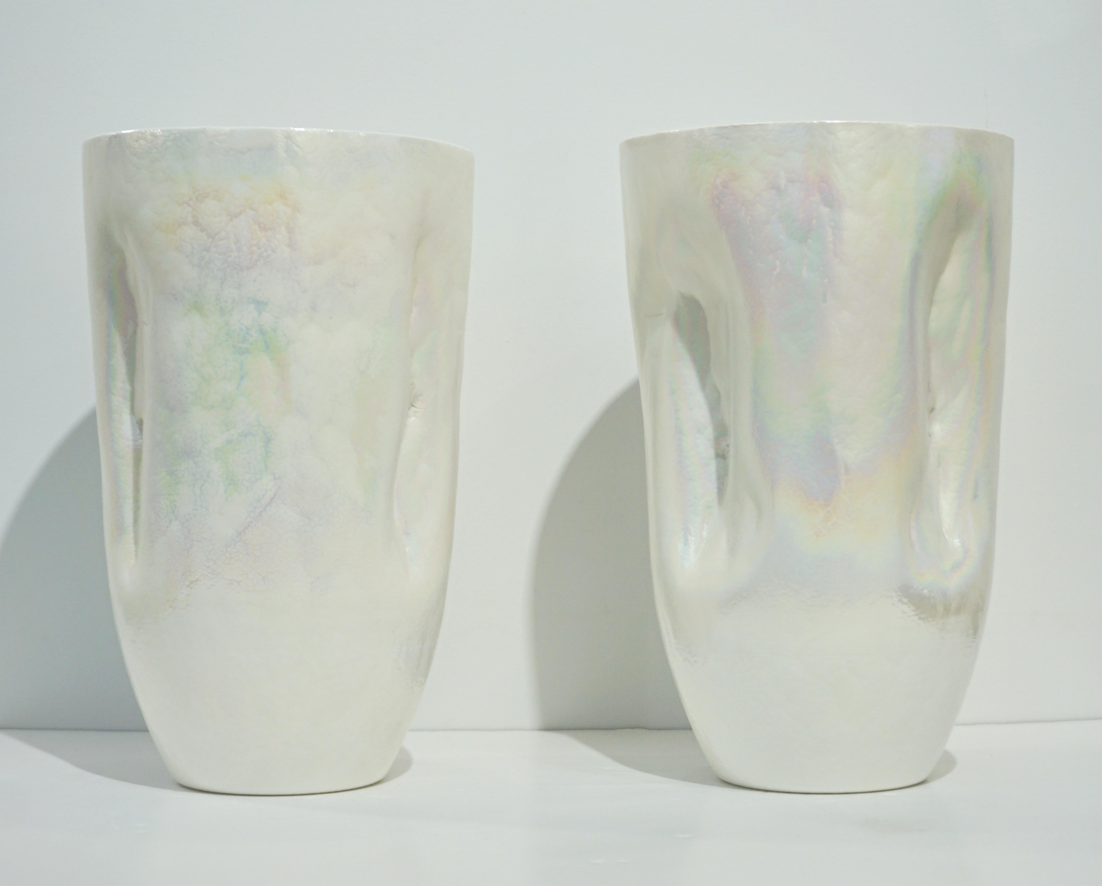 Decorative Italian pair of pearlescent white Murano glass vases of freeform with attractive interesting crumpled shape, the Venetian blown glass has a pâte de verre consistency glowing with an iridescent finish that gives it a mother of pearl