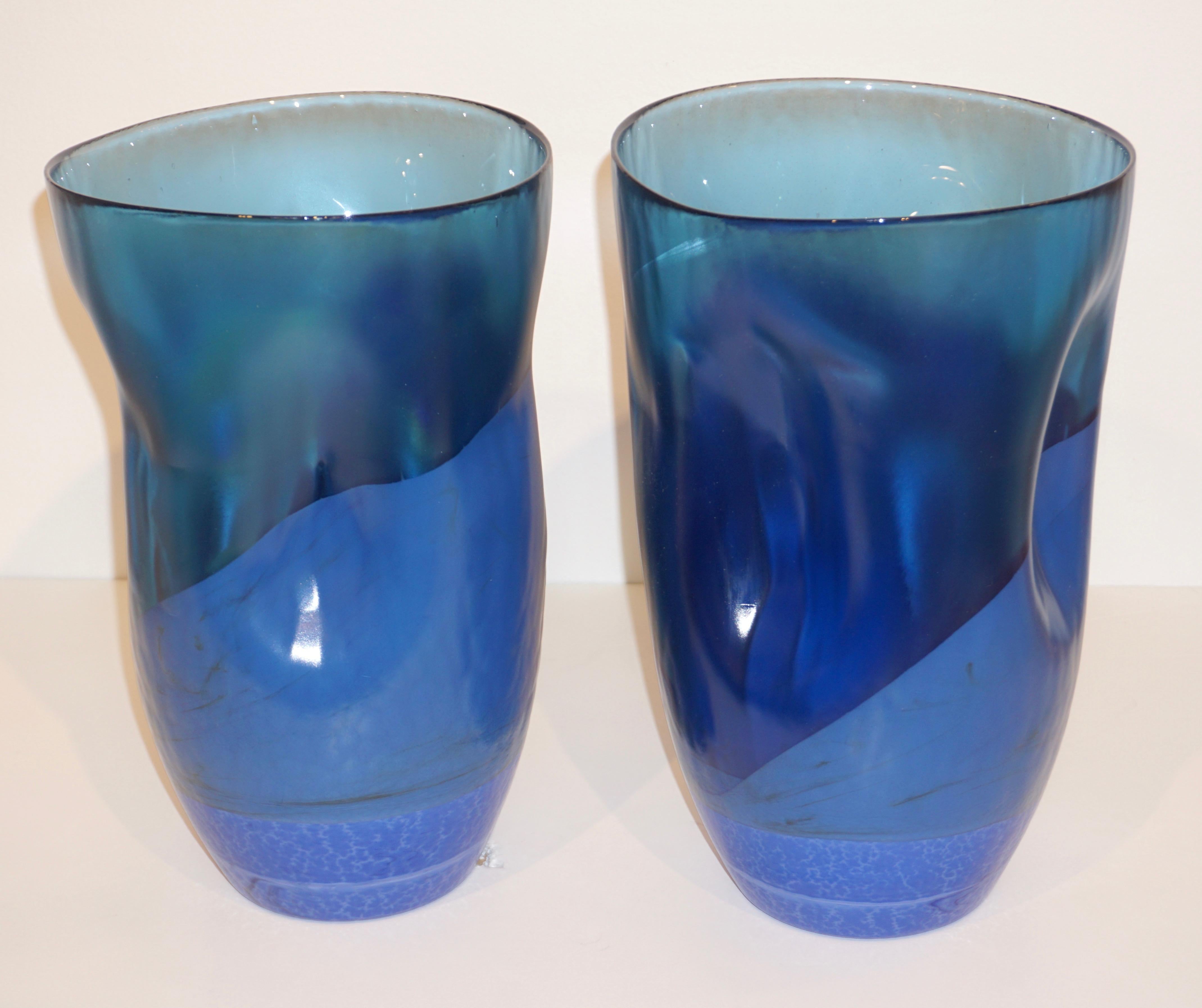 Decorative Italian pair of modernist cobalt aqua blue Murano glass vases of freeform with attractive interesting crumpled shape, the Venetian blown glass has a pâte de Verre consistency with an iridescent finish that gives a glowing movement.
Can