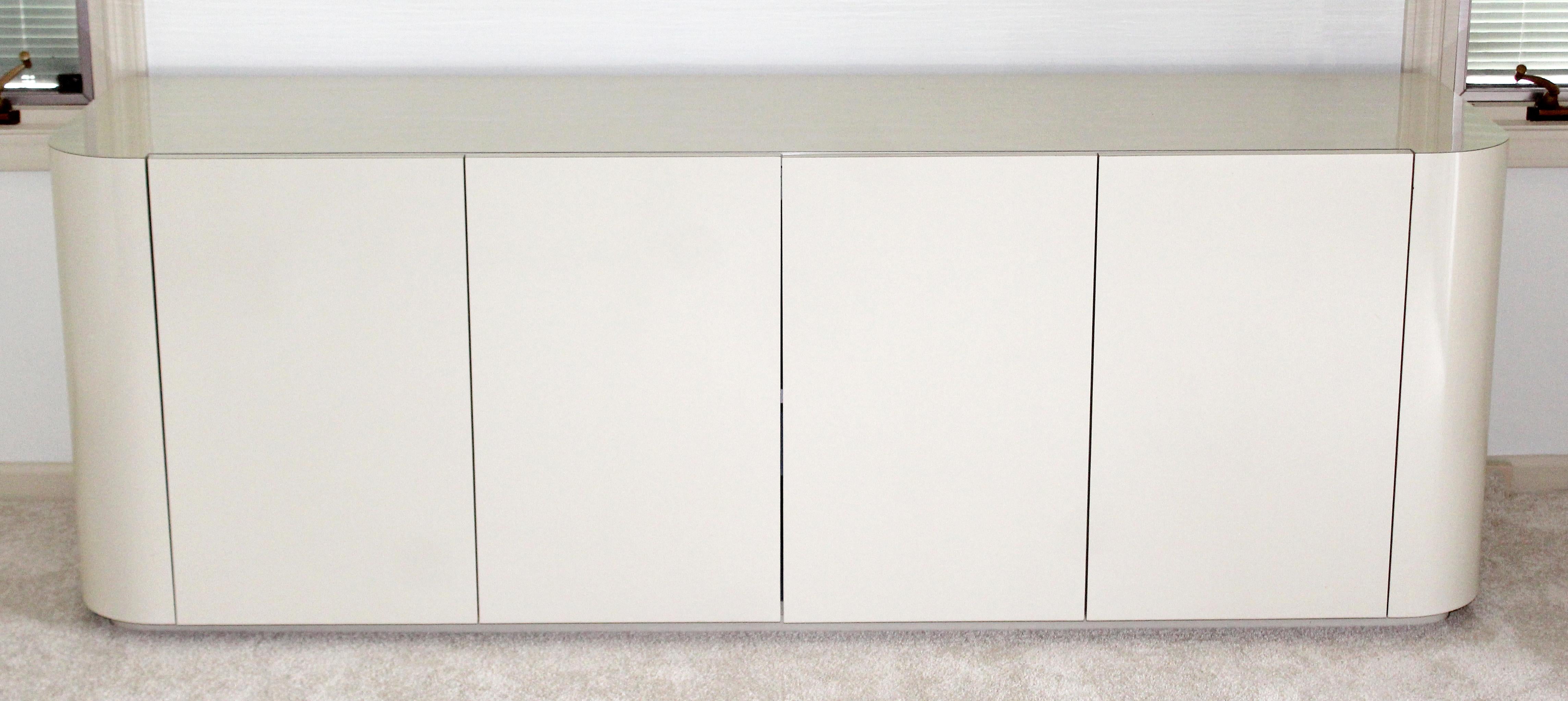 For your consideration is a fabulous, white lacquered credenza cabinet, with four doors, circa 1980s. In very good condition. The dimensions are 77
