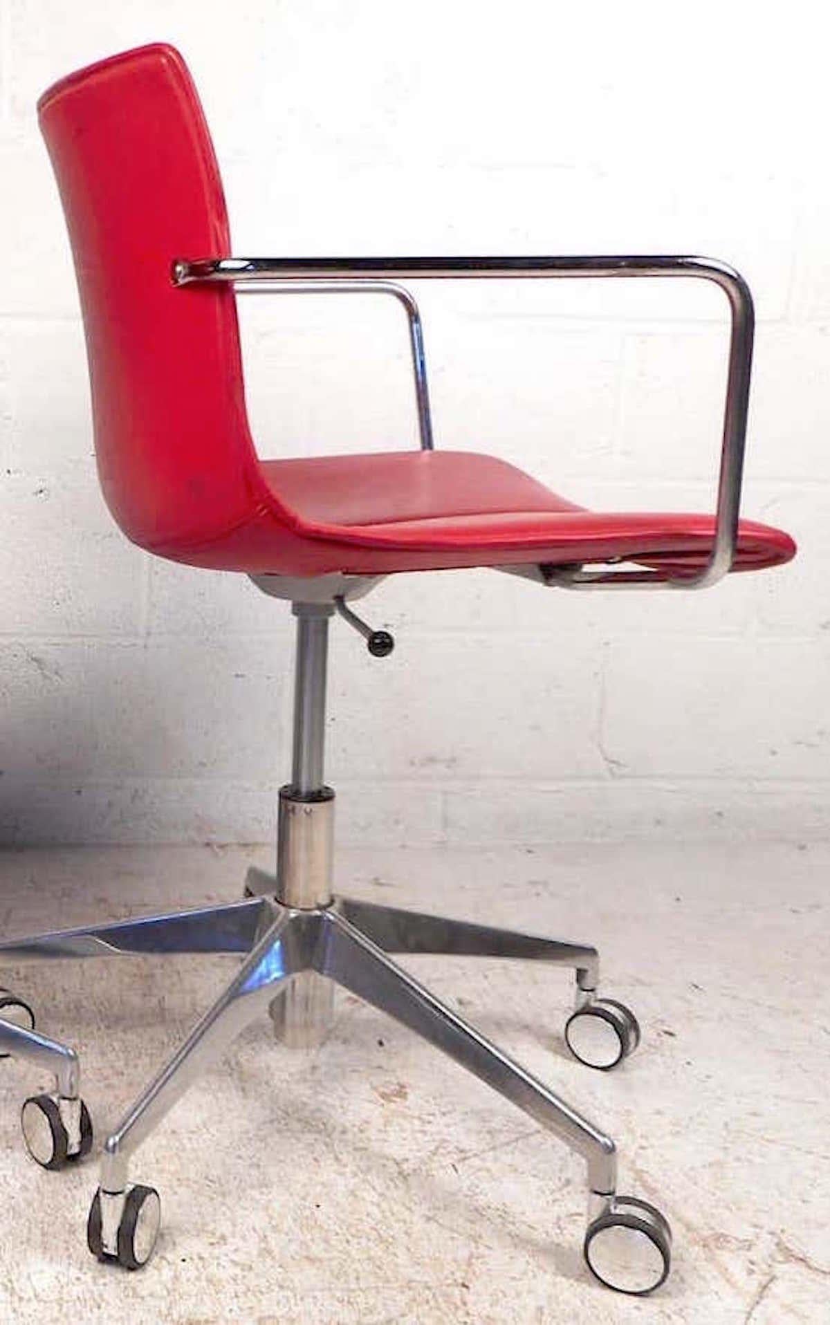 Comfortable form-fitting seat covered in a vibrant red faux-leather upholstery. Sturdy chrome supports, bases, and armrests. Adjustable height settings ranging from 35