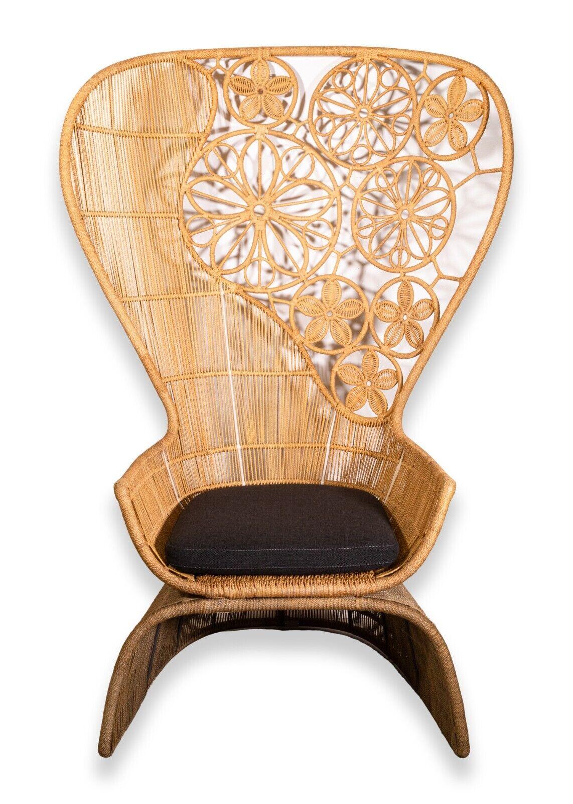 A B&B Italia Crinoline high armchair. This marvelous piece from legendary designers B&B Italia features an iconic peacock chair design. This chair, intented for outdoor use, features a very robust construction and design featuring raised floor