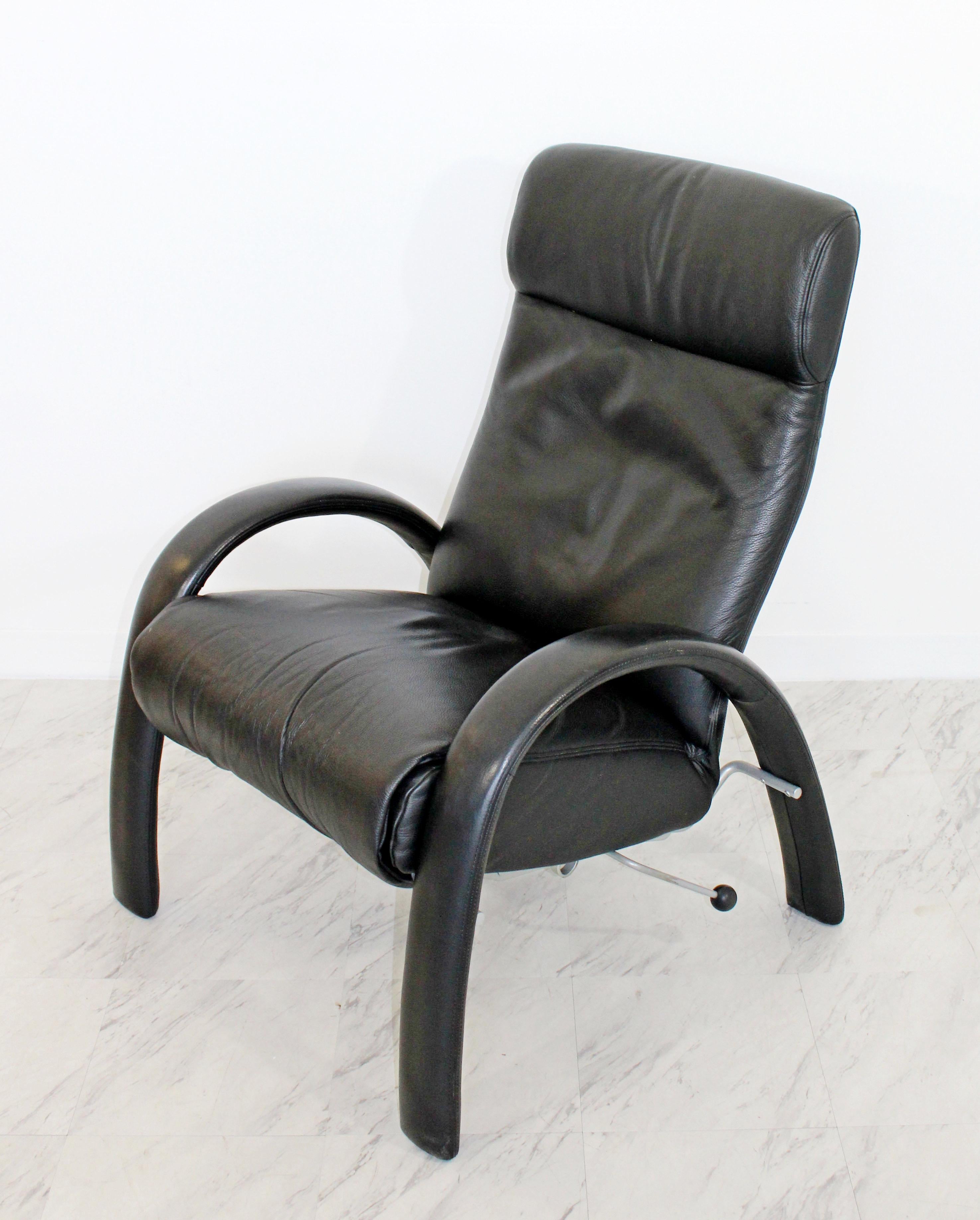 For your consideration is a wonderful Bjork black leather, reclining armchair by Lafer. The back reclines and the footrest extends separately. In excellent condition. The dimensions upright are 29