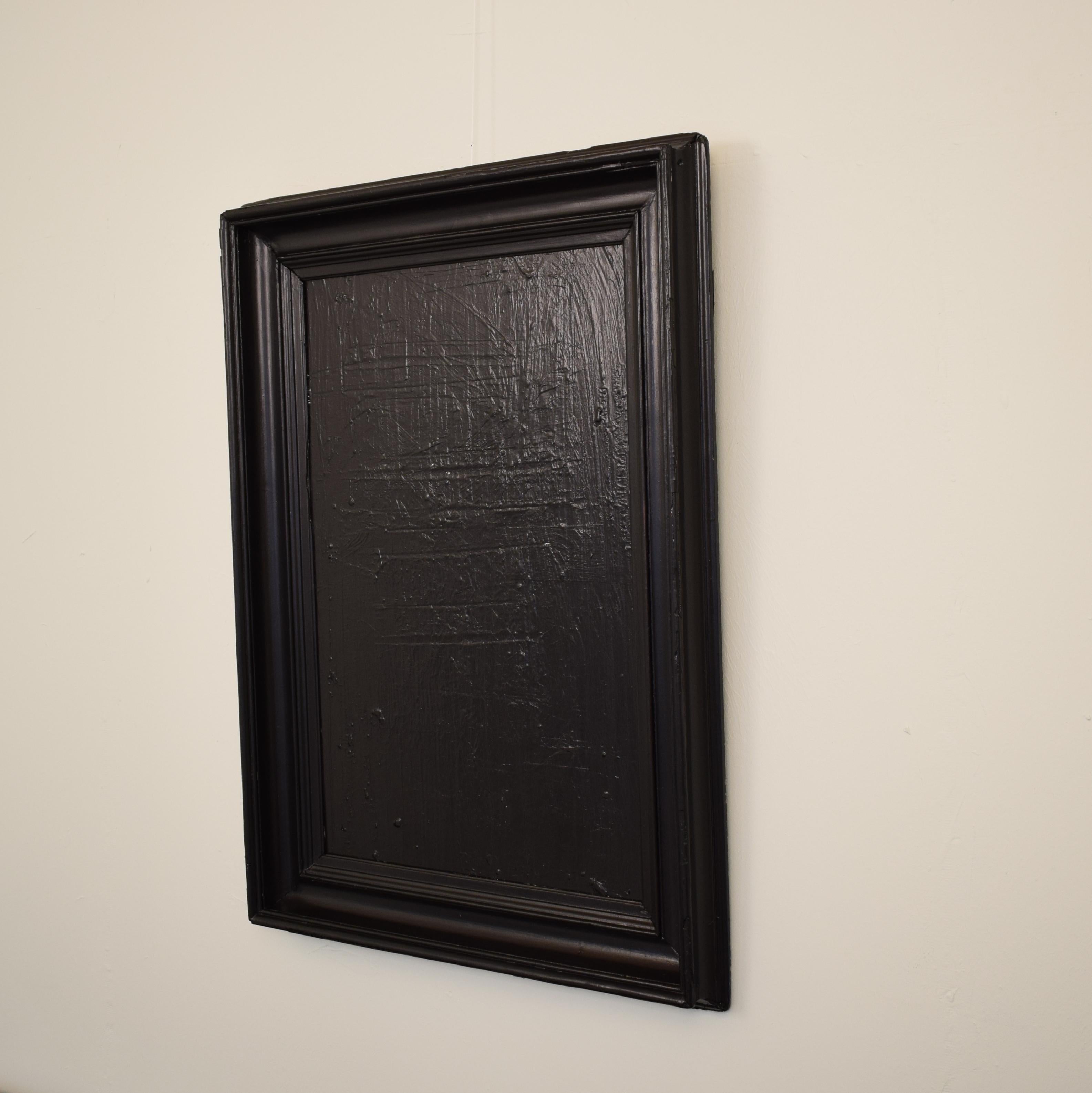 This black painting has heavily textured acrylics on canvas. The artist created the piece using multiple techniques like palet knife, brush and chalk. It is in an old 19th century picture frame. The painting would complement a modern interior design