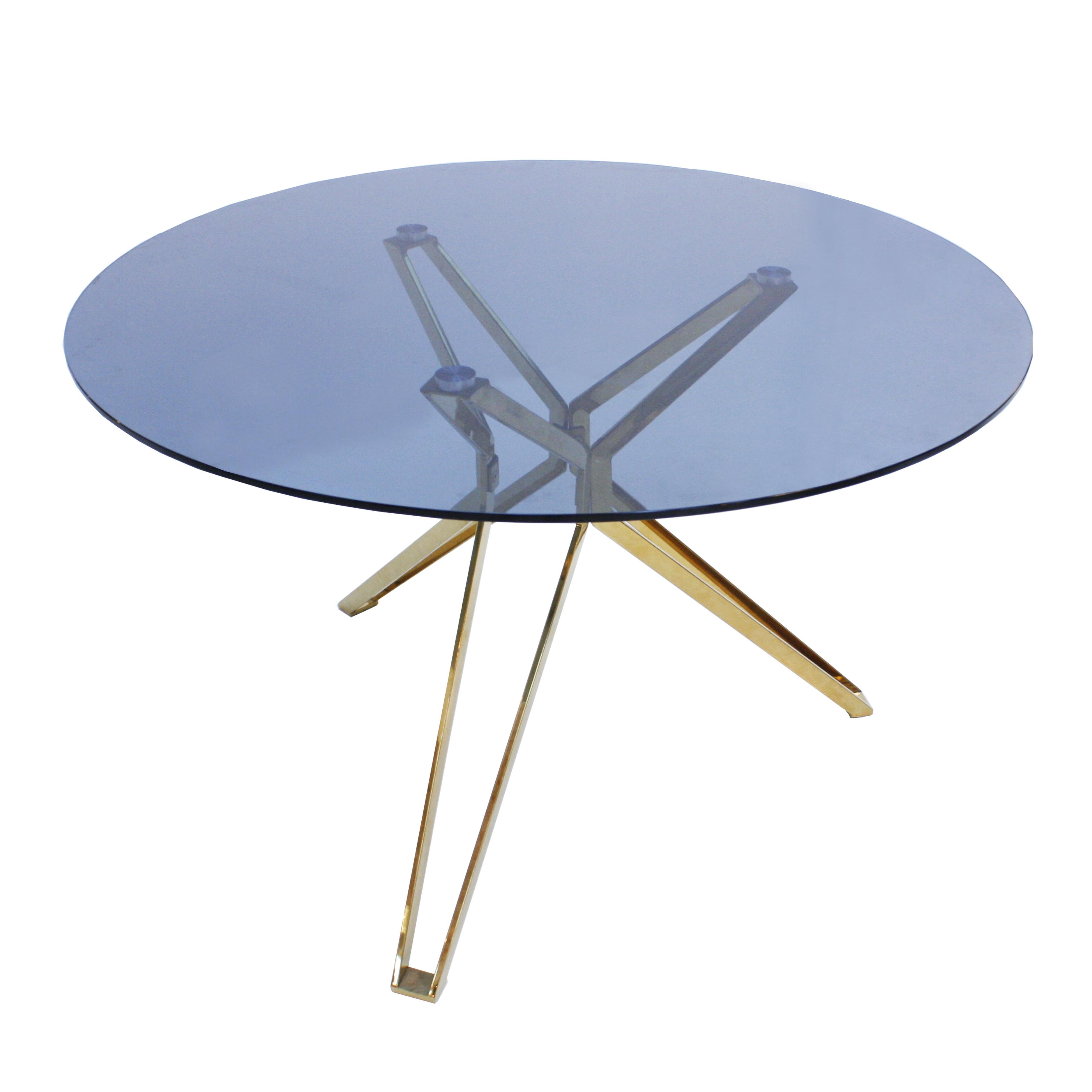 Contemporary circular table. Structure composed of three brass platen shape legs, finished with circular aluminium pieces that support a circular fumé tempered glass top. Made in the Netherlands.


