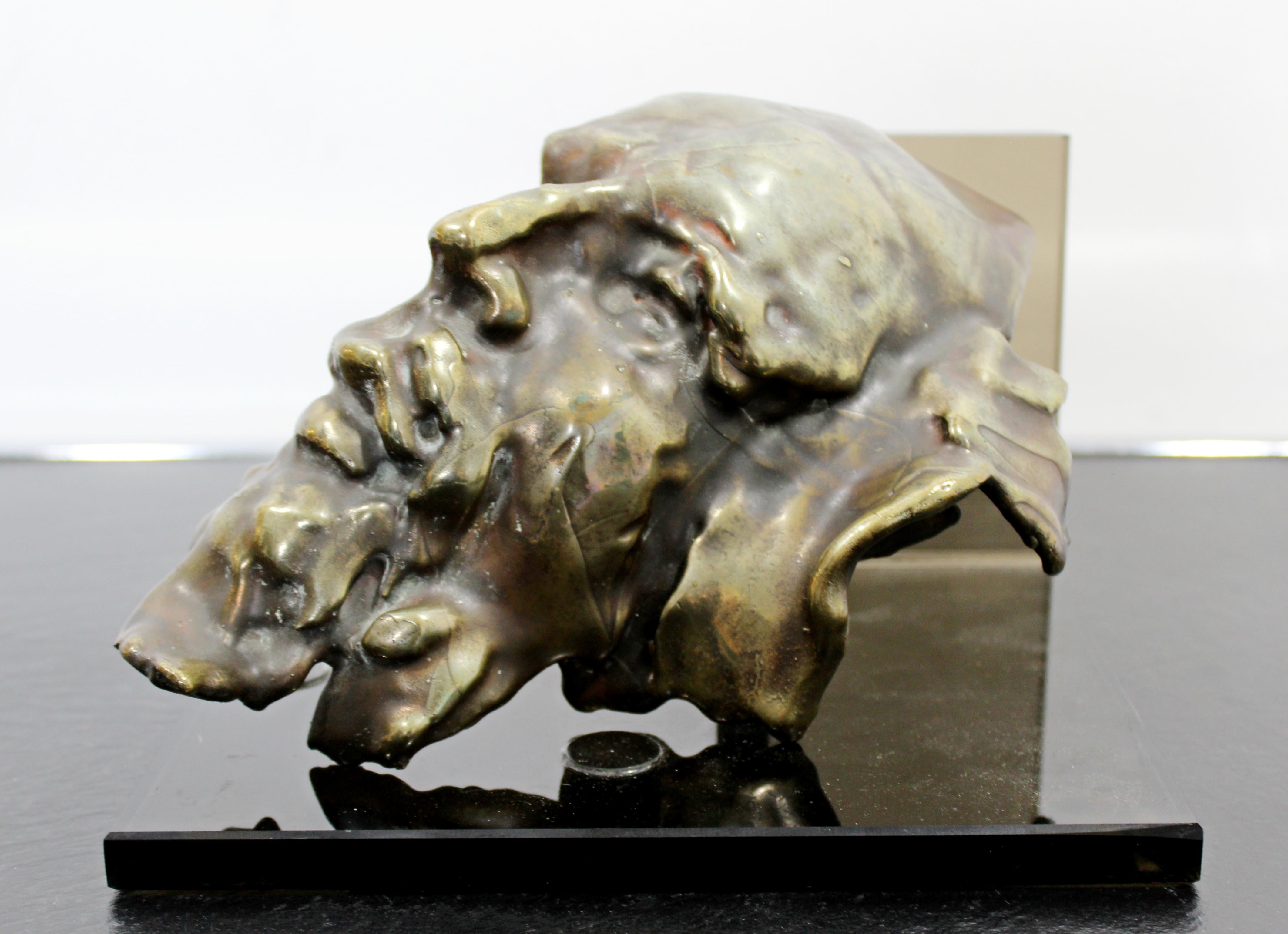 For your consideration is a mesmerizing, bronze table sculpture, of a face, signed by Gordon Hipp, dated 1991. In excellent condition, but the glass stand has chips. The dimensions of the sculpture are 6