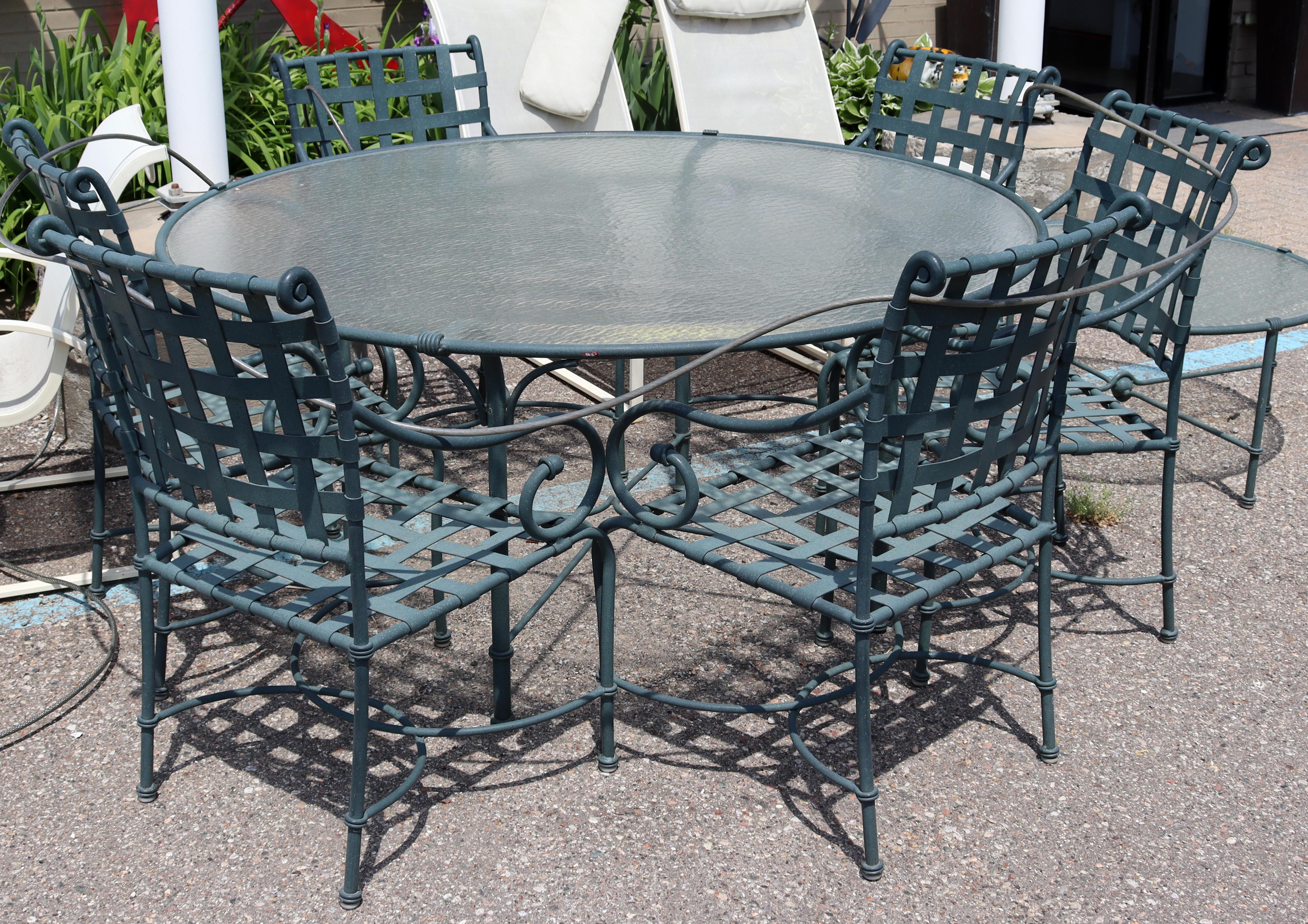 For your consideration is a phenomenal patio set, including a dining table, six dining chairs, a side or coffee table, and a pair of chaise lounges, by Brown Jordan, circa the 1980s. In excellent vintage condition. The dimensions of the dining