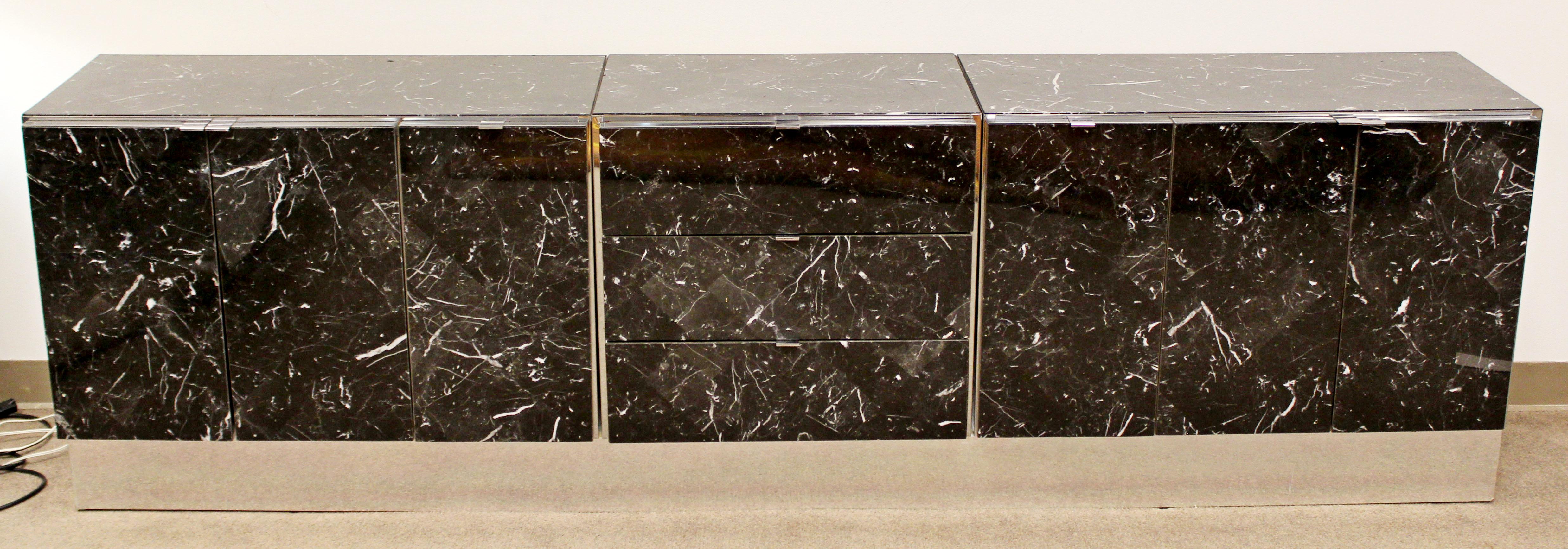 For your consideration is a gorgeous, black tessellated marble and chrome credenza, on a chrome base, with four drawers by Ello, circa 1980s. In good condition. The dimensions are 97.5