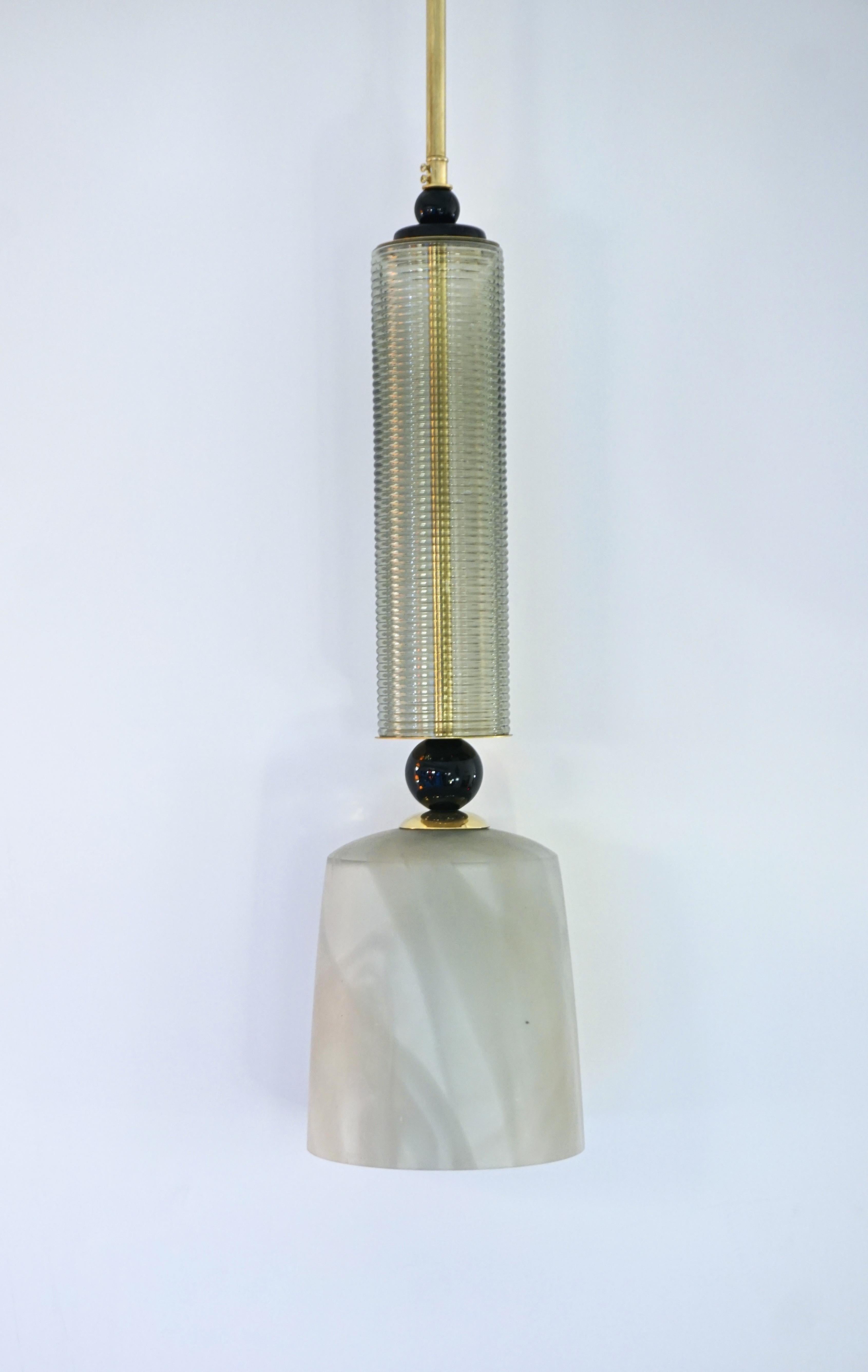 Price is per individual item - Fun and elegant Italian pendant chandelier, entirely handcrafted, of organic modern design consisting of a succession of elements: black opaline glass accents highlighting a mouthblown reeded glass cylinder, a handmade