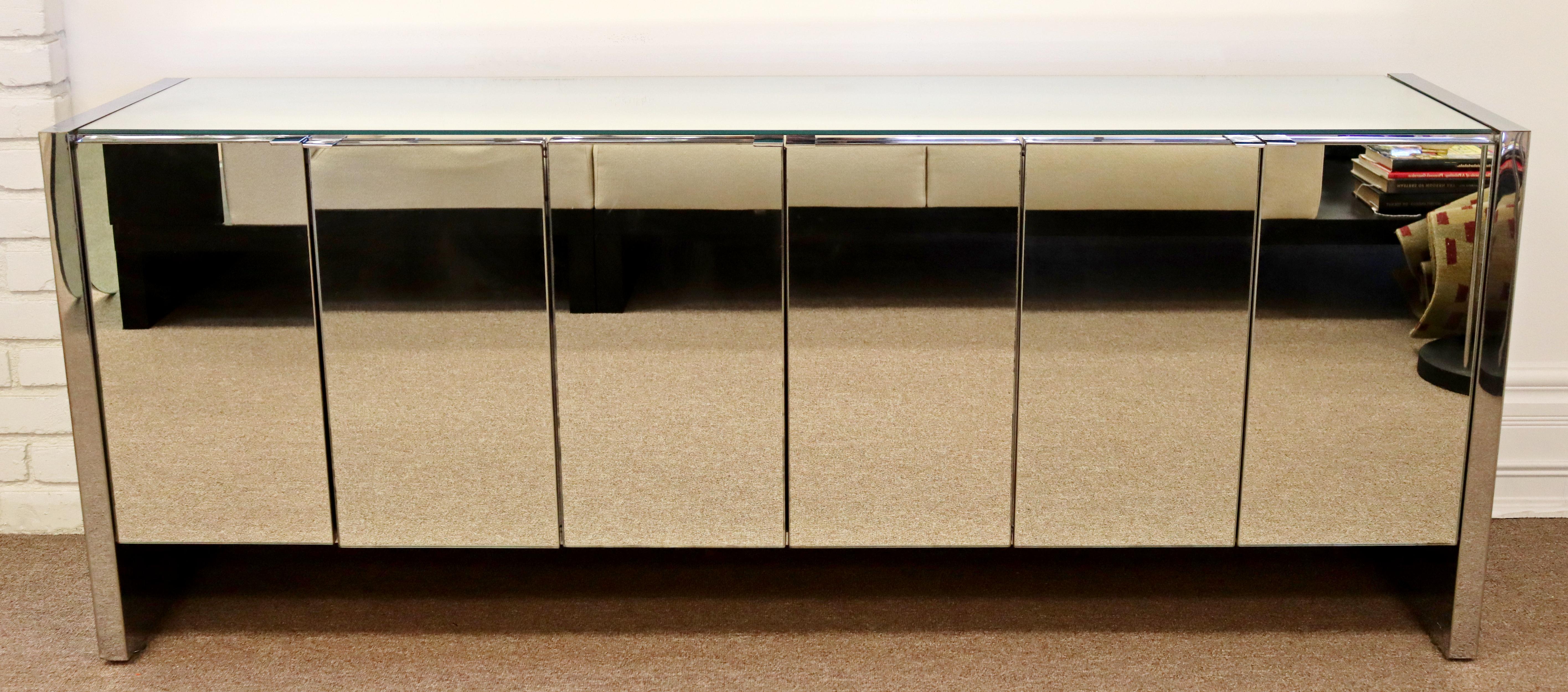 For your consideration is an elegant, mirrored credenza, with chrome trim, by Ello, circa the 1980s. In excellent vintage condition. The dimensions are 75