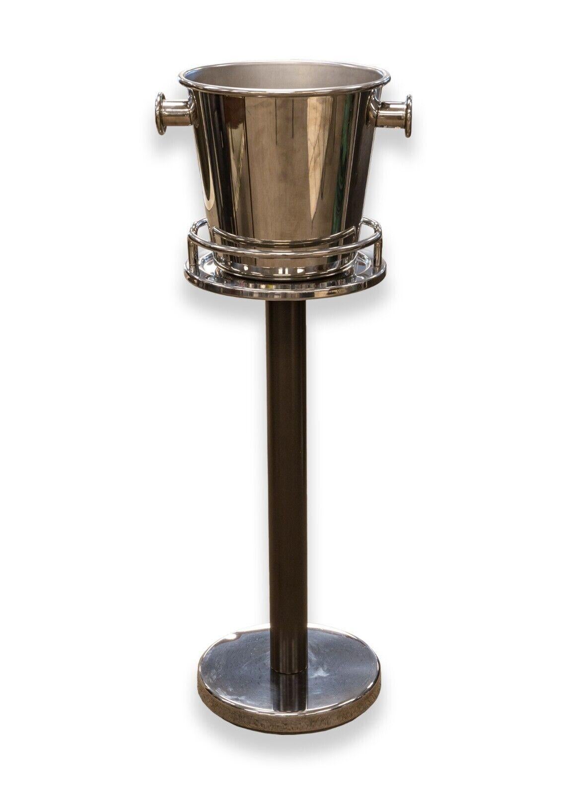 A contemporary modern Ettore Sottsass for Alessi chrome wine cooler and stand. A lovely freestanding bottle cooler from Alessi. A beautiful piece for any home bar or kitchen. This piece features a chrome metal construction, and a dark brown metal