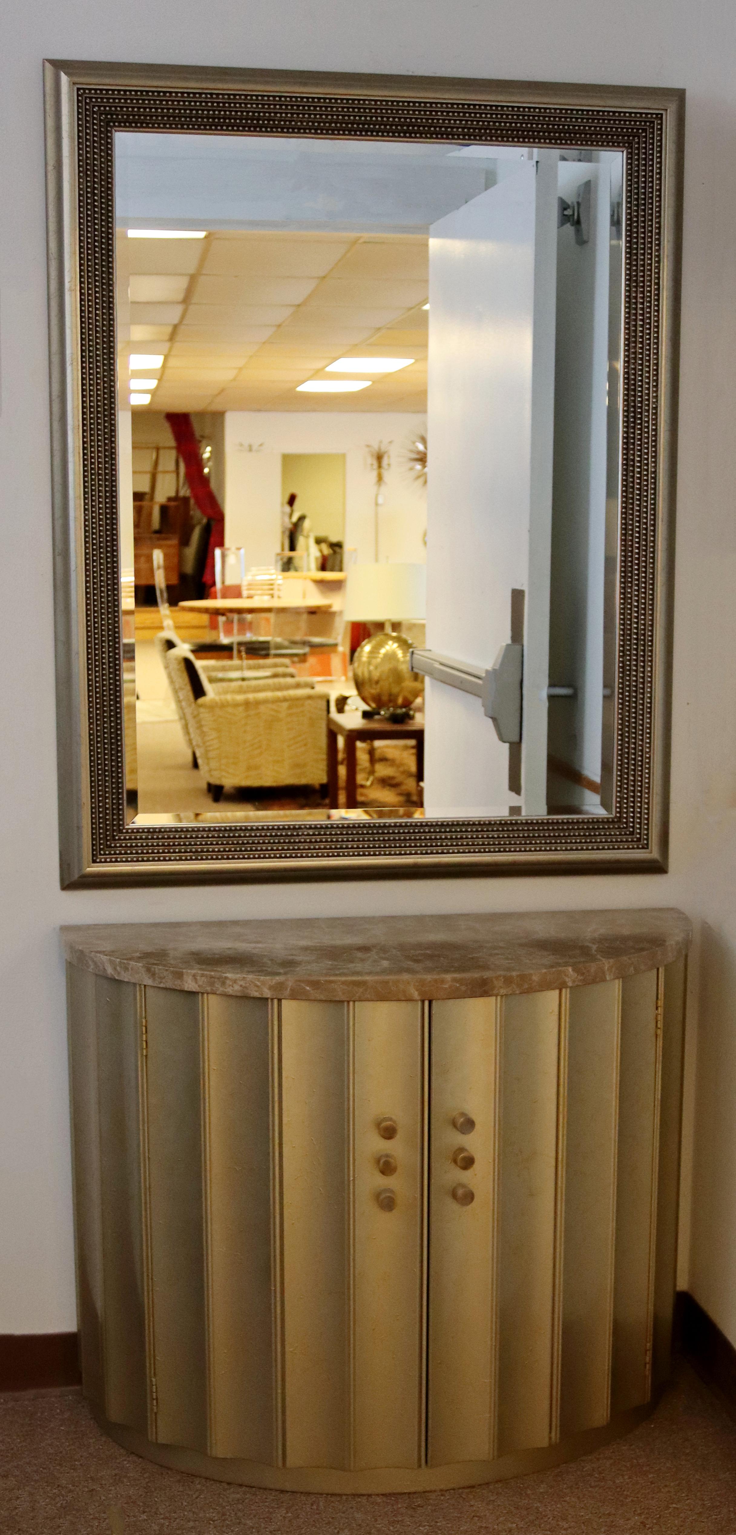 For your consideration is a phenomenal, gold gilt wall mirror and matching, marble topped demilume console table, with one shelf, circa the 1980s. In excellent vintage condition. The dimensions of the mirror are 37