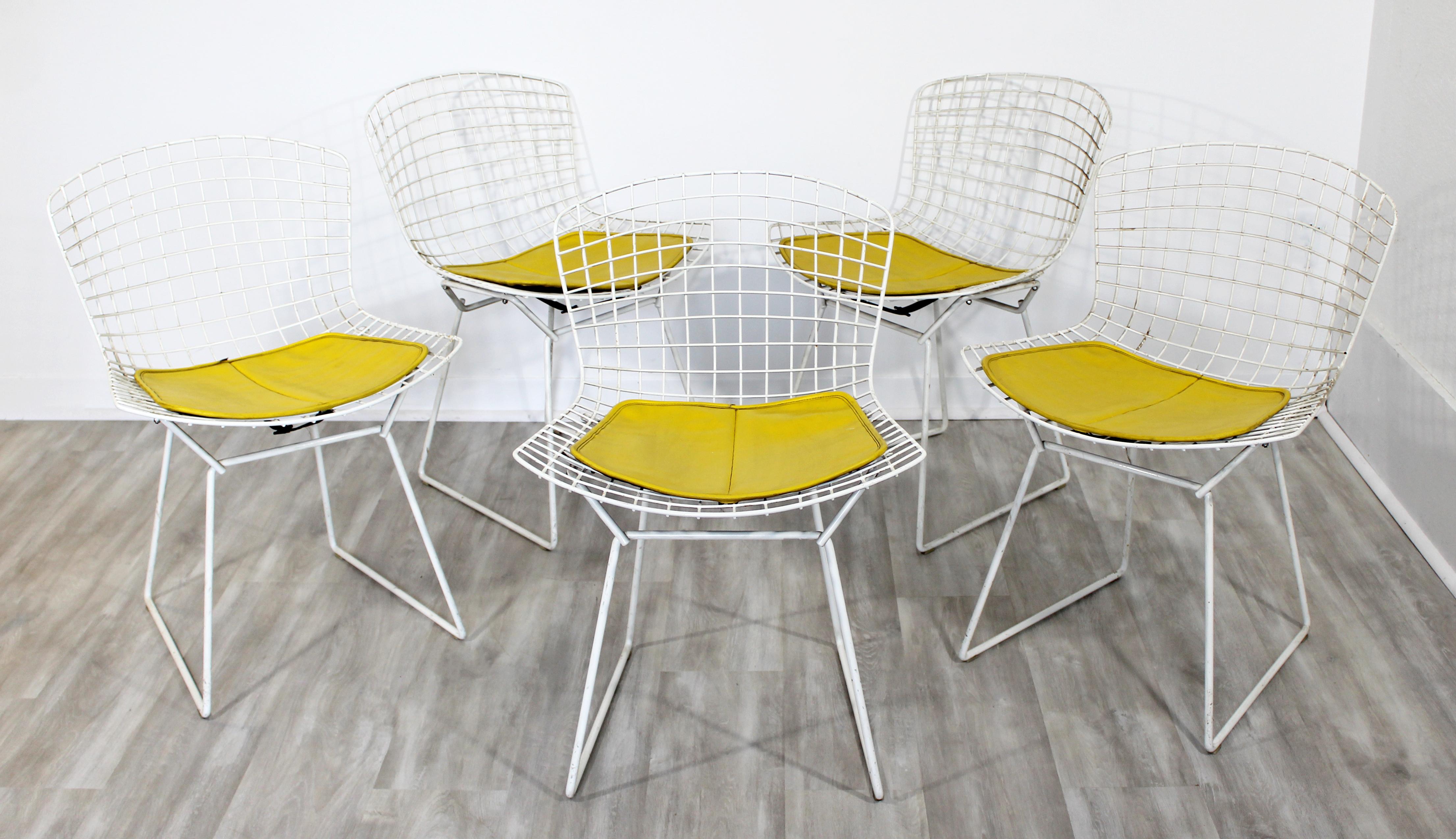 For your consideration is a phenomenal, original set of five white side chairs, with original yellow pad seats, by Harry Bertoia for Knoll, circa 1980. In very good vintage condition. The dimensions are 21