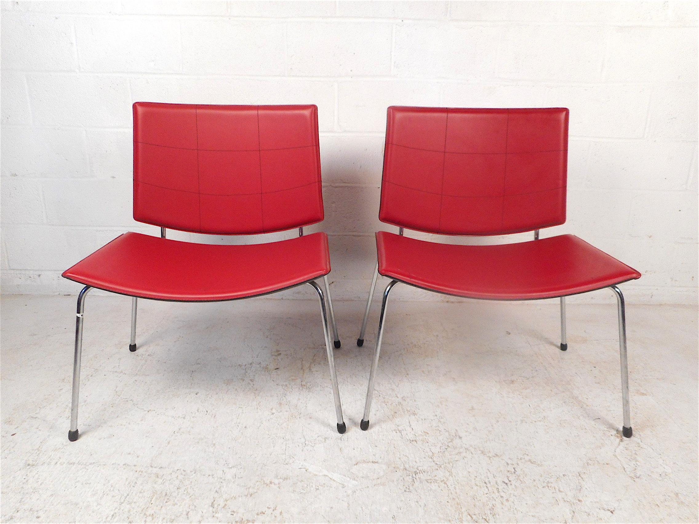 Stylish pair of modern chairs. Very spacious and comfortable seats and backrests. Covered in a red vinyl upholstery, supported by a sleek chrome frame. Made in Italy. This pair would make a great addition to any modern interior. Please confirm item