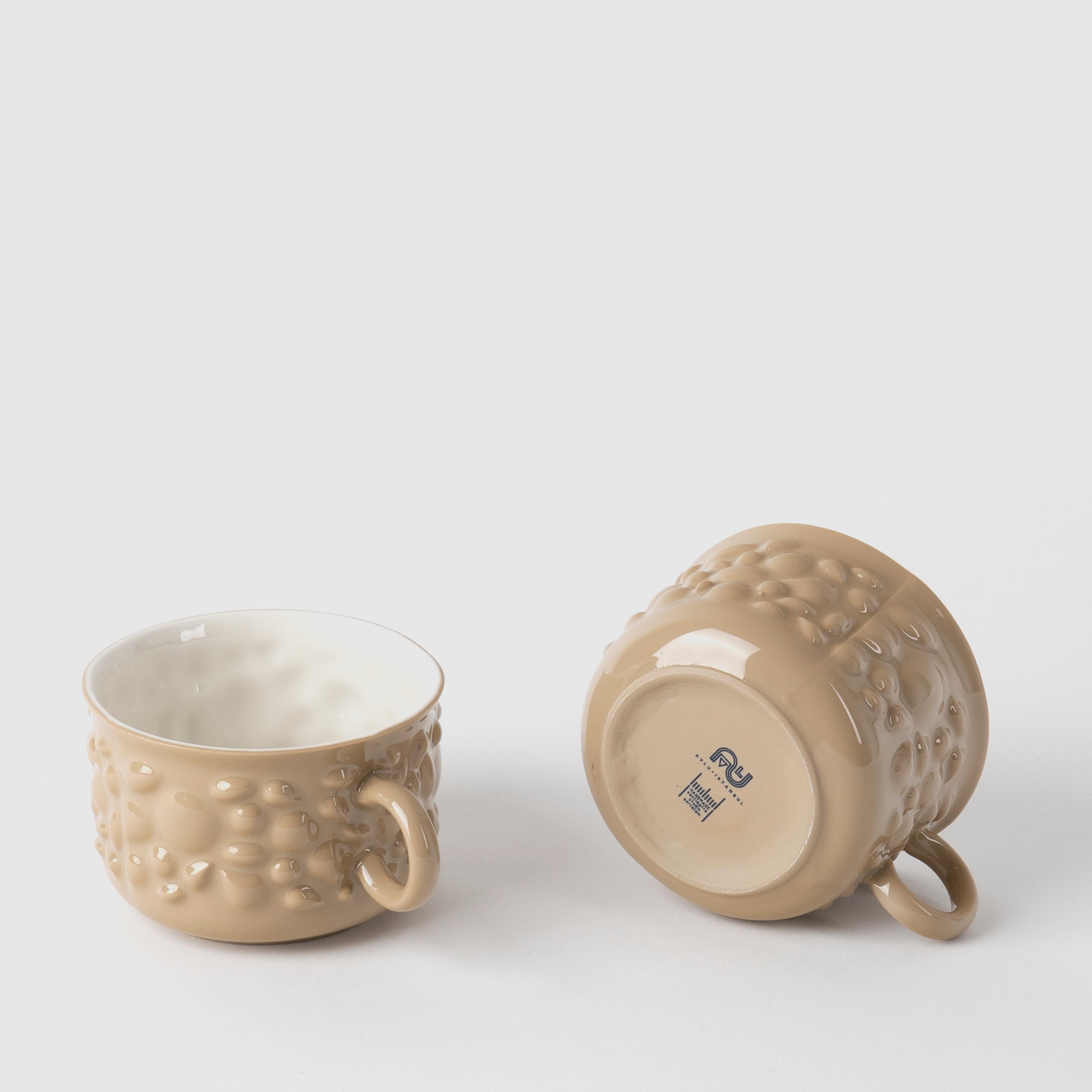 Justine porcelain pieces are inspired by the ancient Byzantine jewelry. Delicate porcelain transforms cups into timeless design objects by translating pearl and stone details of jewelry into flowing forms.

With their pastel colors and delicate