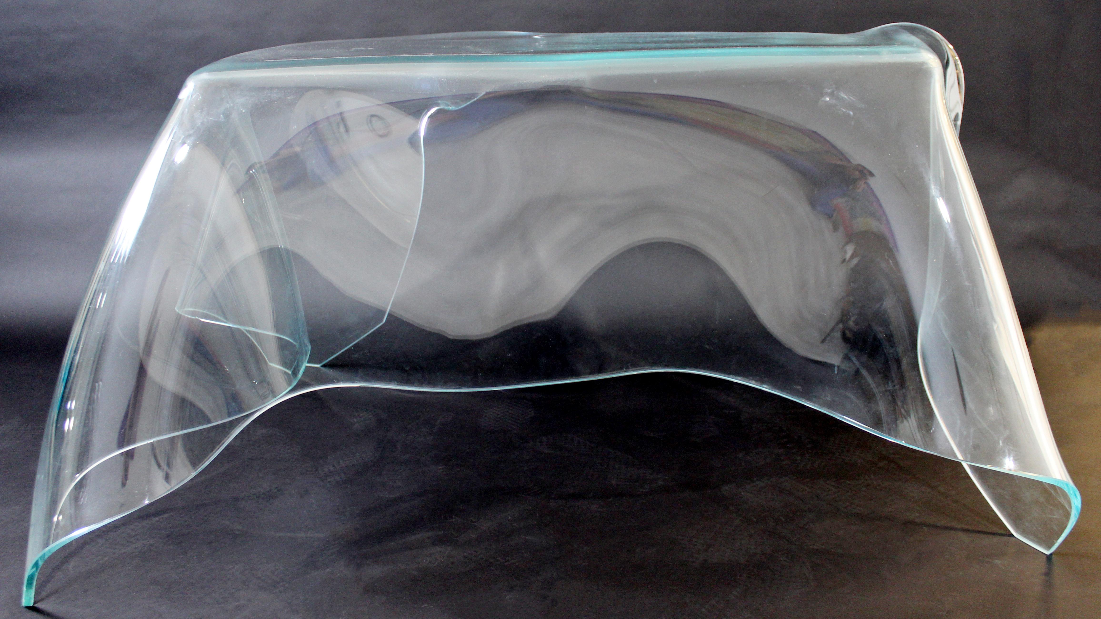 For your consideration is an simply show stopping piece of art in the shape of a slumped and draped glass desk. Made of a thick, clear sheet of glass that has been manipulated by the world renowned glass artist, Laurel Fyfe, circa 1980s. In very