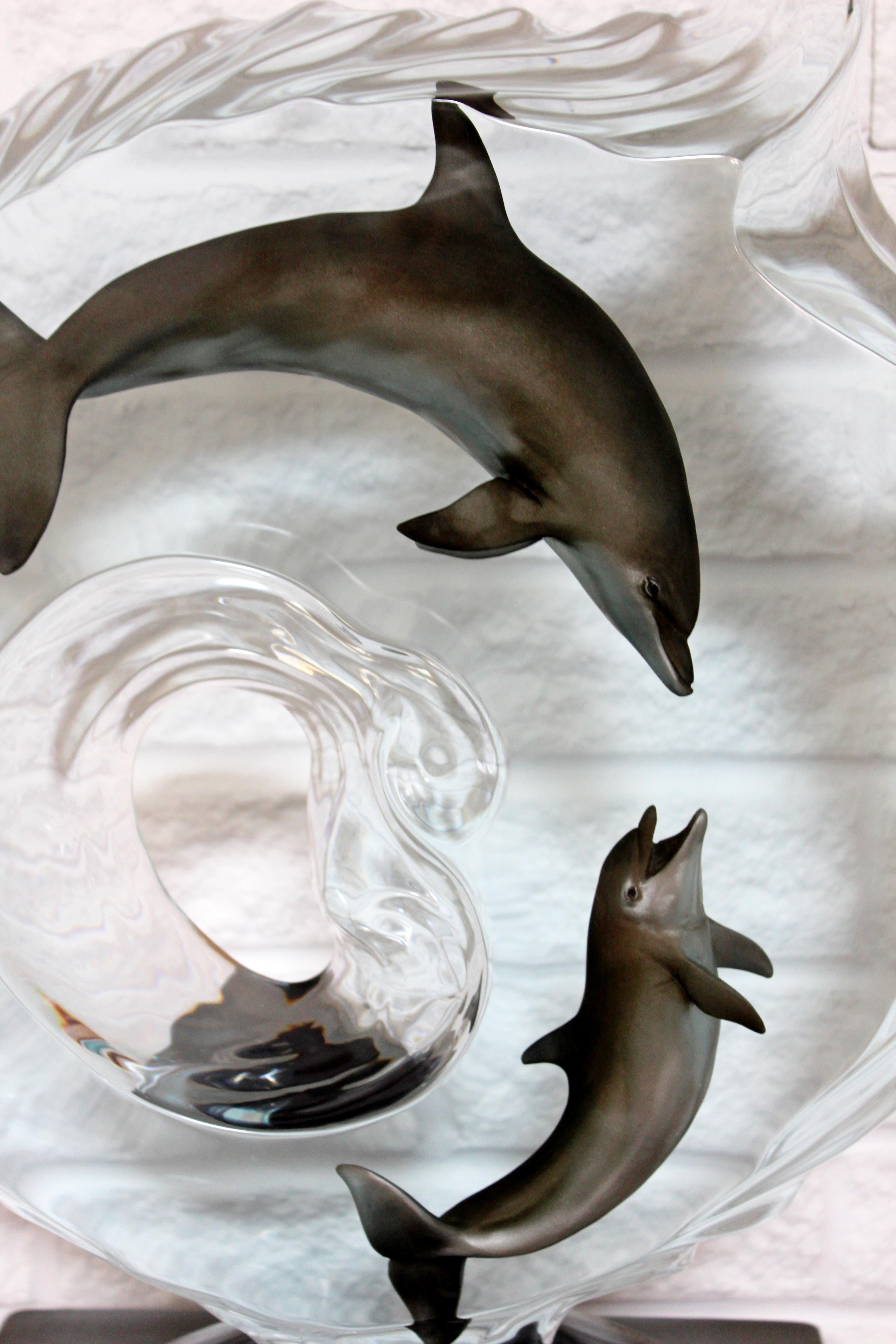 For your consideration is an a stunning, Lucite acrylic table sculpture of a couple of dolphins, signed Medina. In excellent condition. The dimensions are 18