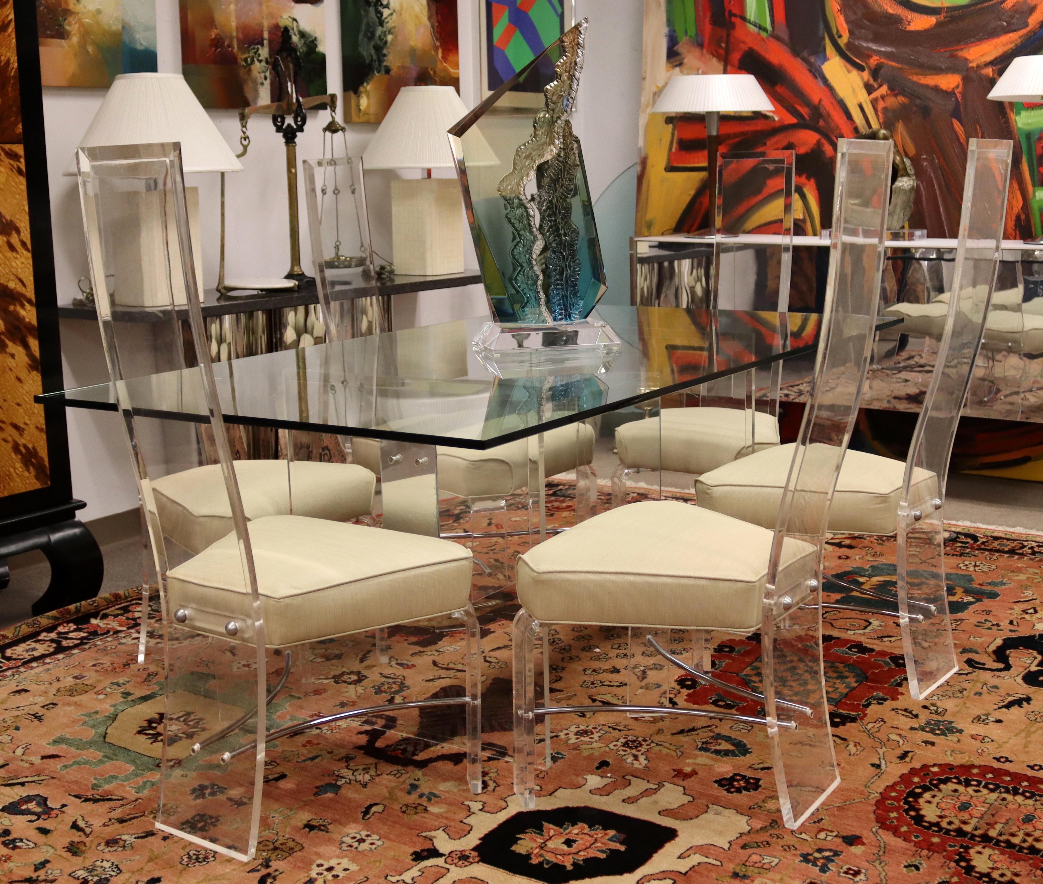 For your consideration is a minimalist dining set, including a lucite and chrome table, with a set of six high back chairs, circa the 1980s. In very good vintage condition. The dimensions of the table are 72