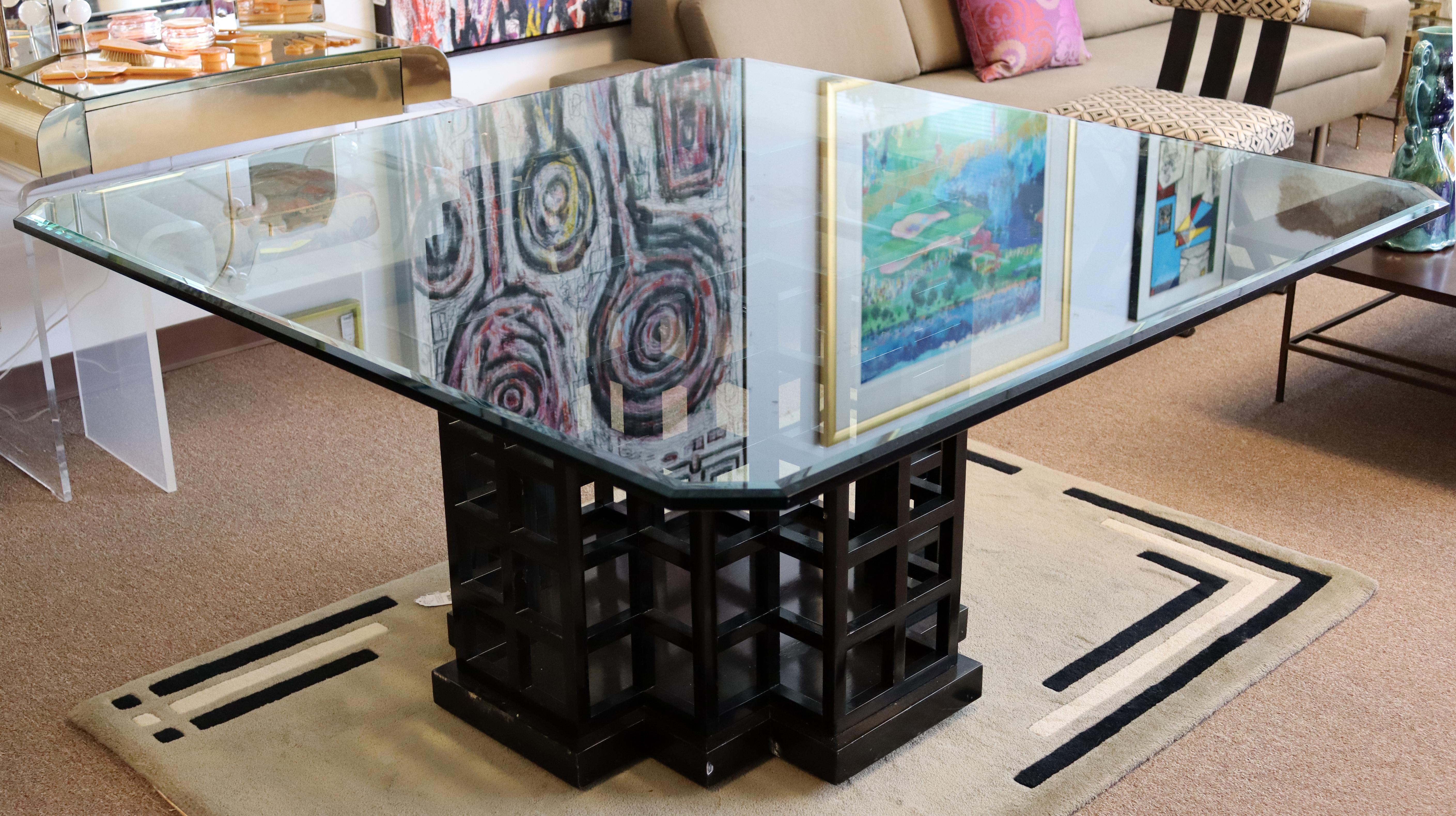 For your consideration is a magnificent and massive dining table, with a geometric patterned cube wood base and a square glass top, by Dakota Jackson, circa the 1990s. In very good condition, but with a few nicks in the wood. The dimensions are 60