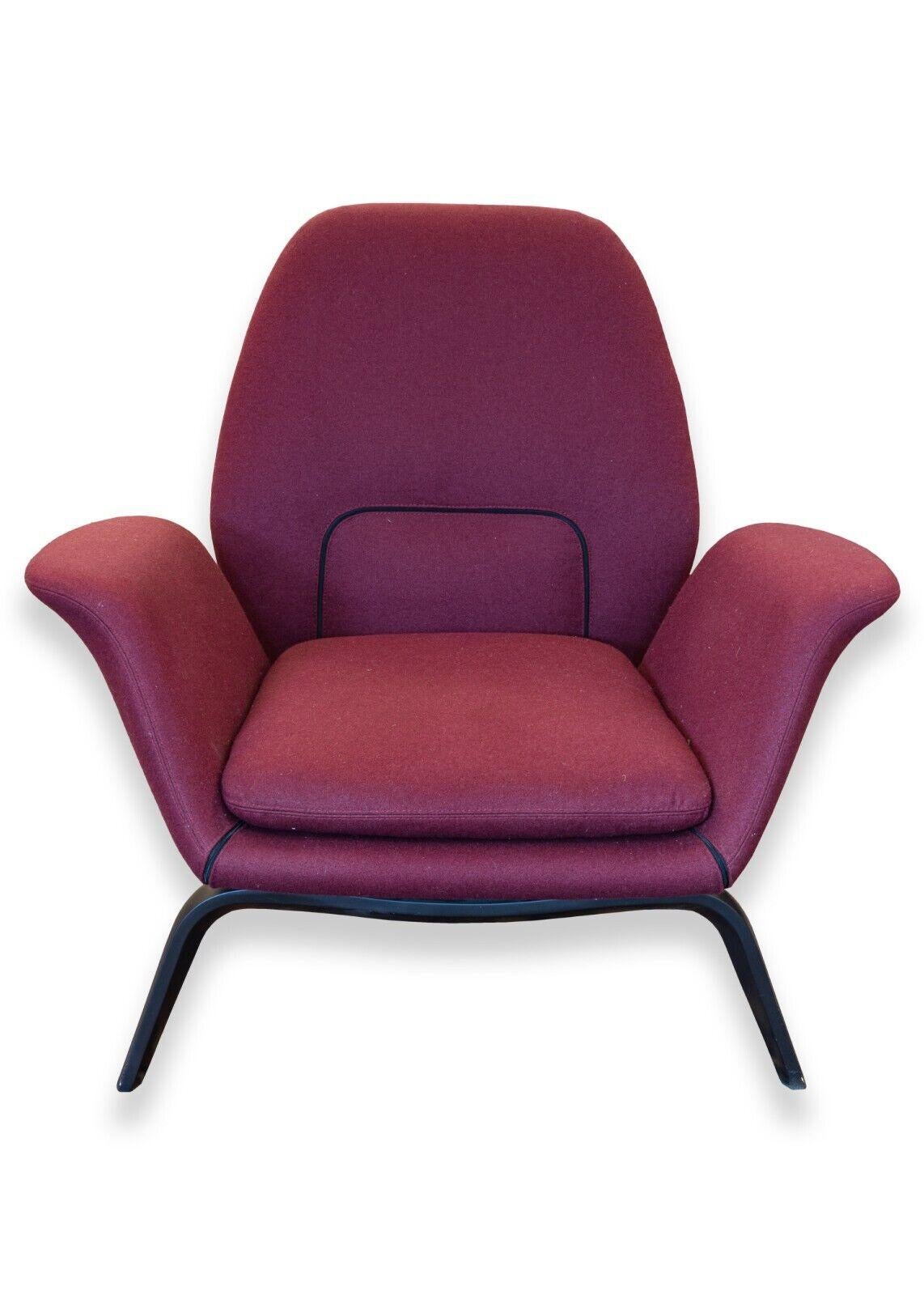 A Minotti Gilliam armchair. A delightful armchair from Italian furniture designers Minotti. The Gilliam armchair features a wonderful, playful silhouette. The design showcases curves from every angle of viewing with a very organic feeling. This