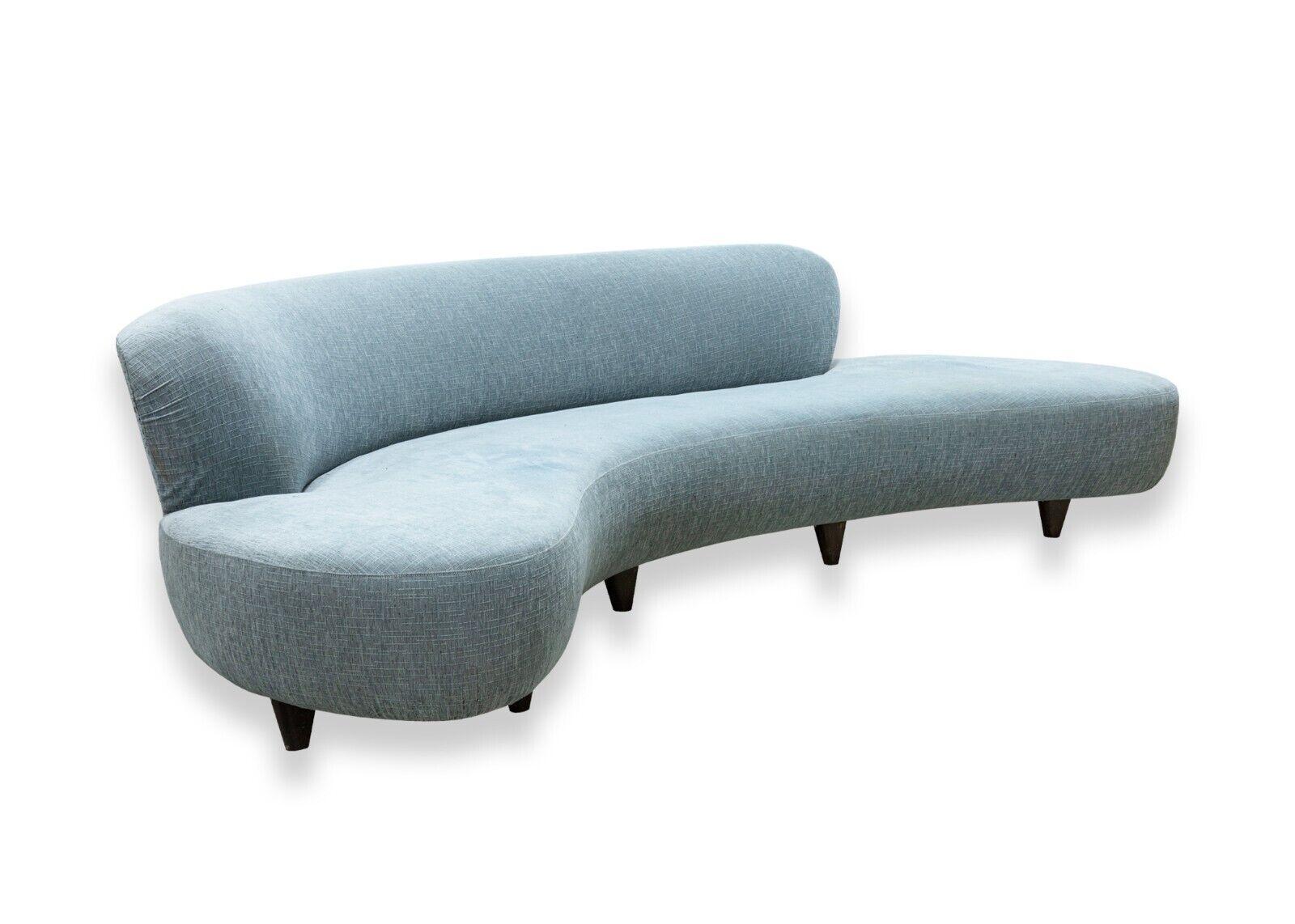 A contemporary modern Modernica style baby blue colored cloud sofa with walnut legs. This sofa features a gorgeous baby blue upholstery fabric with crosshatched line details up close. Supporting this artfully crafted sofa are 8 rounded walnut wood