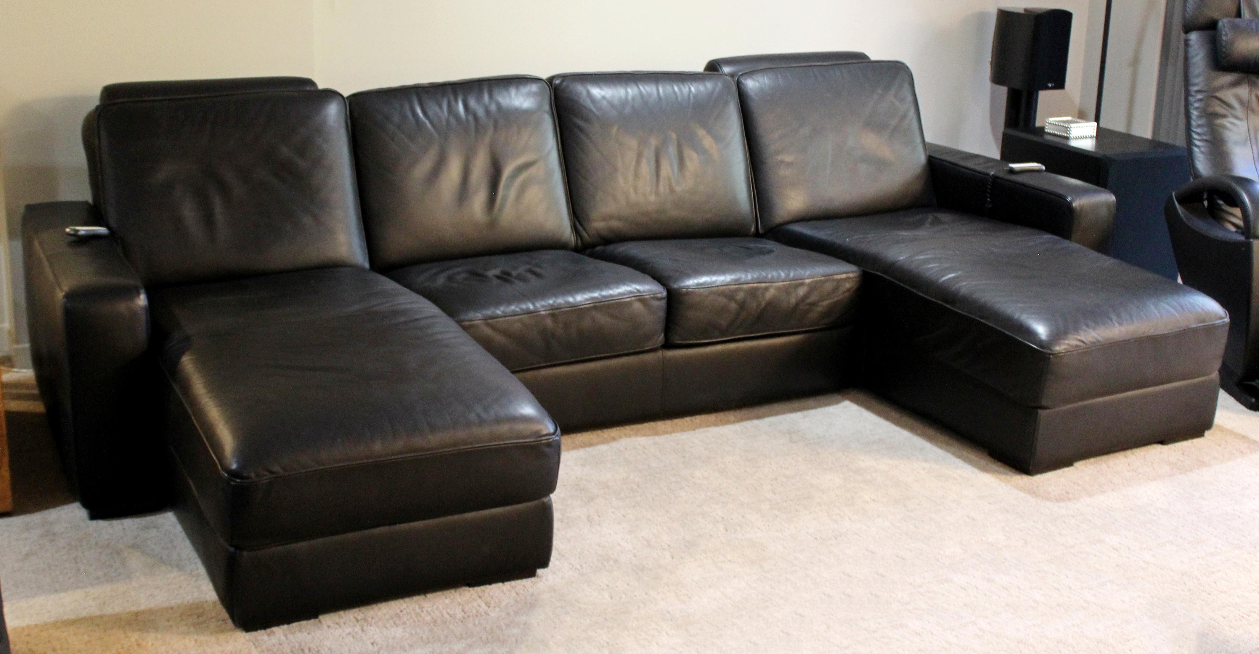 For your consideration is a Natuzzi, black leather, two-seat sectional sofa, with a pair of matching chaises, circa 1980s. In very good condition. The dimensions are 116
