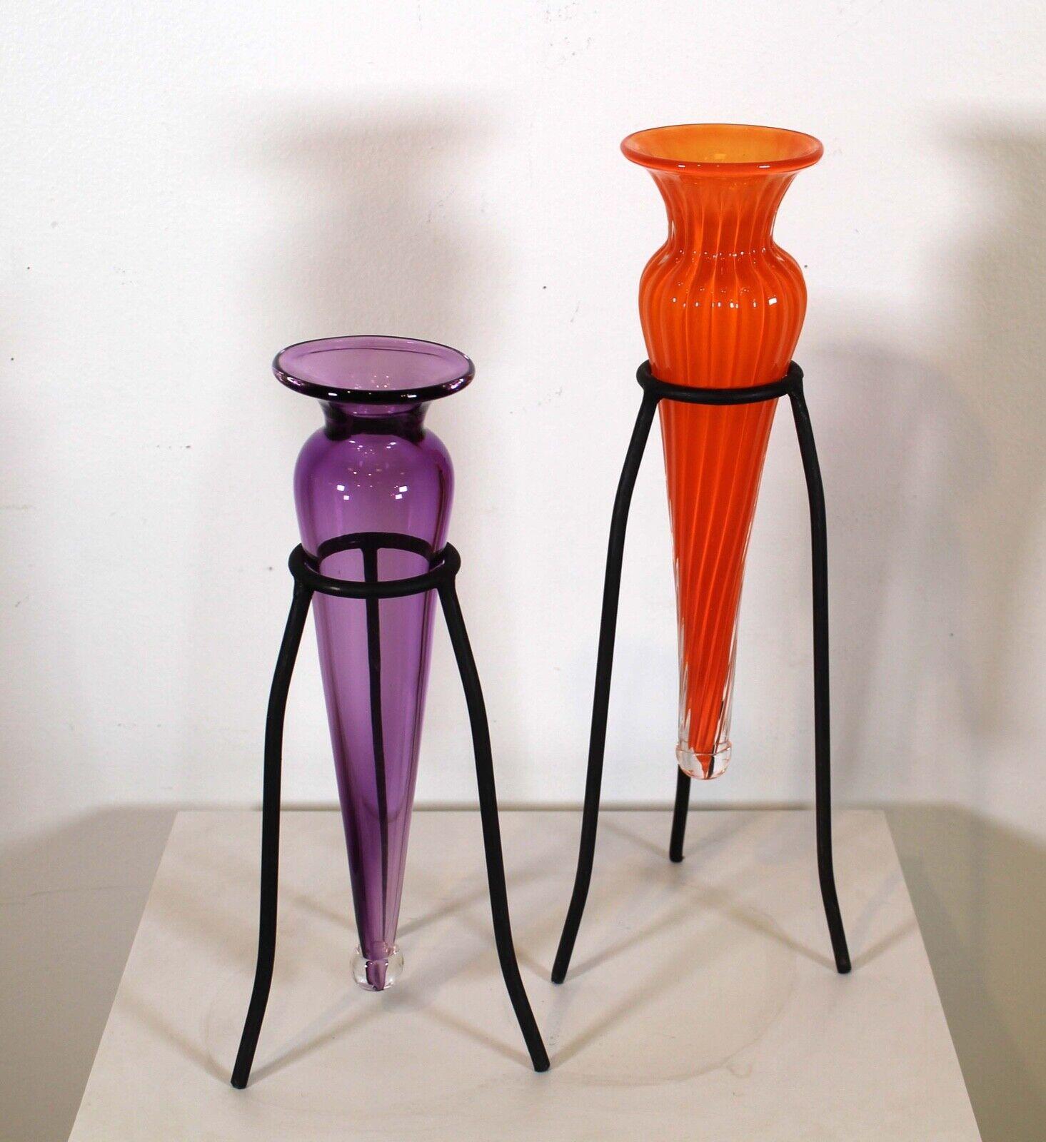 These captivating pair of handblown (one orange, one purple) vases with iron holders. In very good condition. Dimensions: Purple: 5