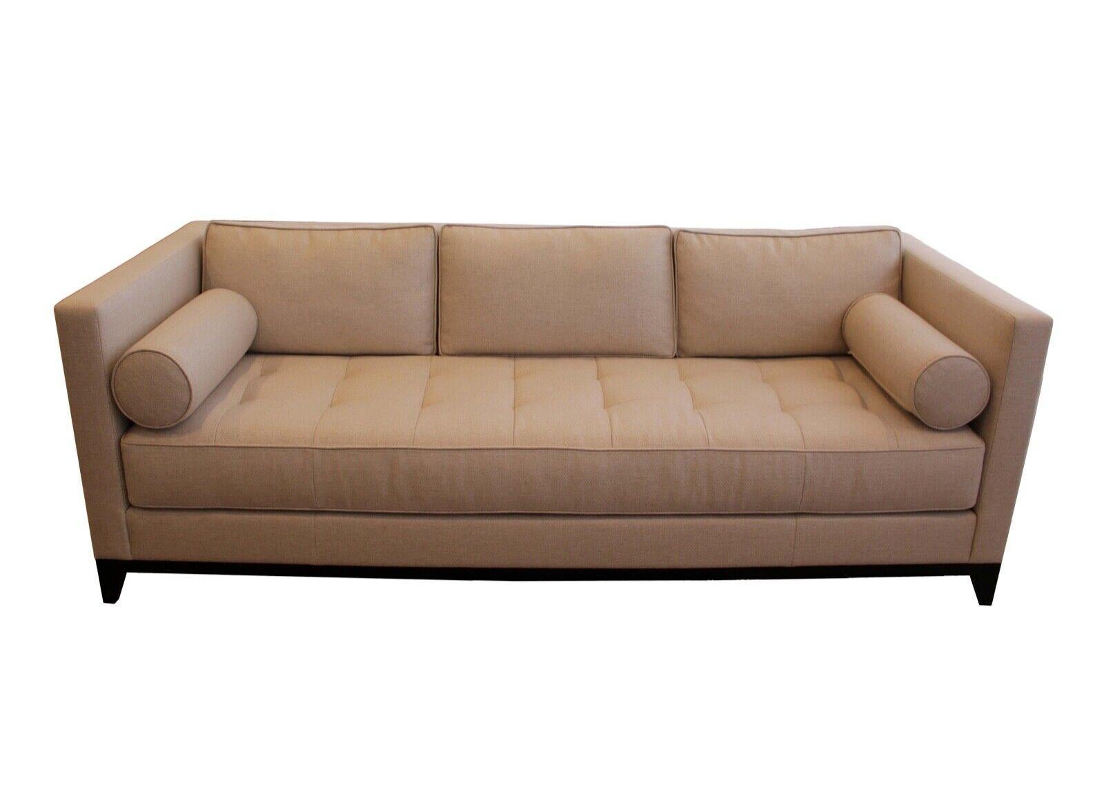 These exquisite interior craft sofas are upholstered in luxurious holly hunt fabric in a beautiful beige color are up for consideration. The contemporary design features plush cushions and a sturdy construction, making it perfect for any living