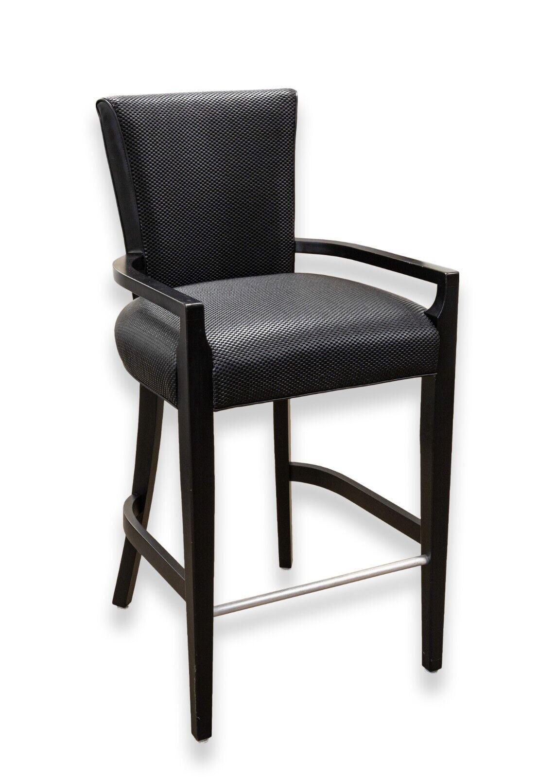 A contemporary modern pair of woven black leather and wood bar height barstools. A very handsome pair of black barstools. These stools feature a black wood construction with aluminum details, and a woven black leather upholstery. These chairs are