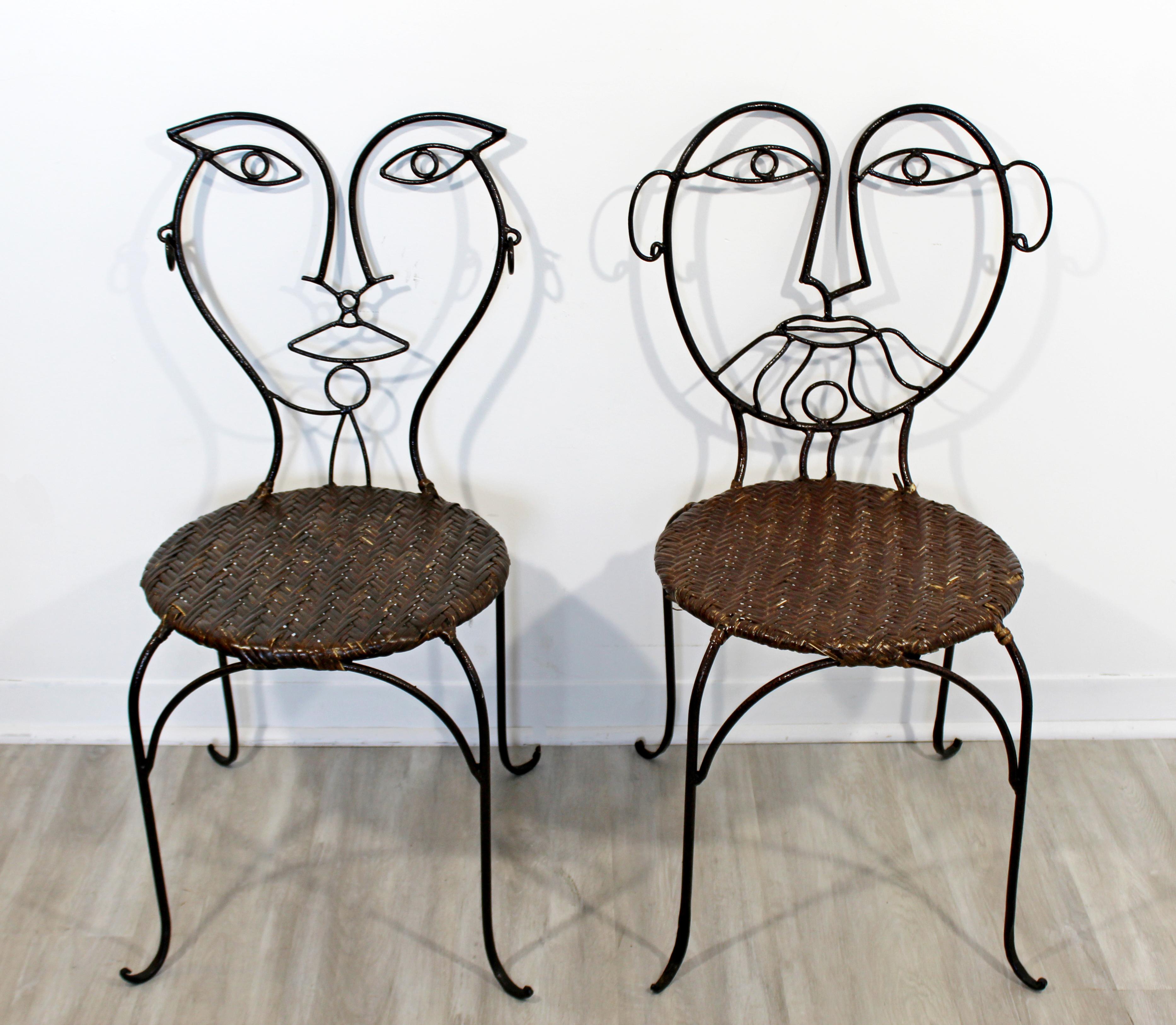 For your consideration is a whimsical pair of cafe art side chairs, made of wrought iron and with rattan seats. In excellent vintage condition. The dimensions are 17