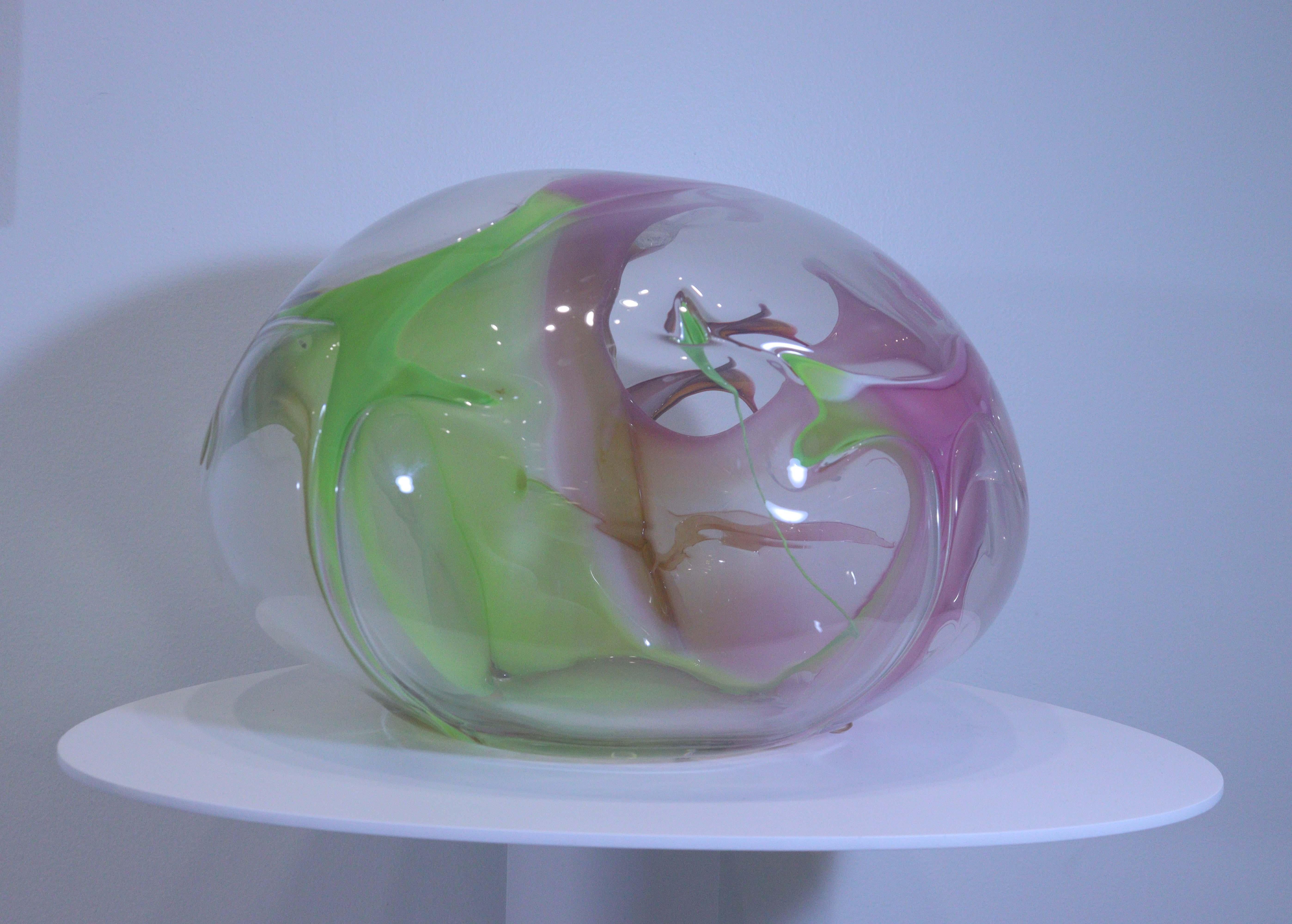 An amazing piece of art glass, this hand blown, glass orb sculpture is biomorphic and organic in nature with free form colors running throughout. Created by Peter Bramhall, this orb is signed and dated by the artist on the underside. An amazing,