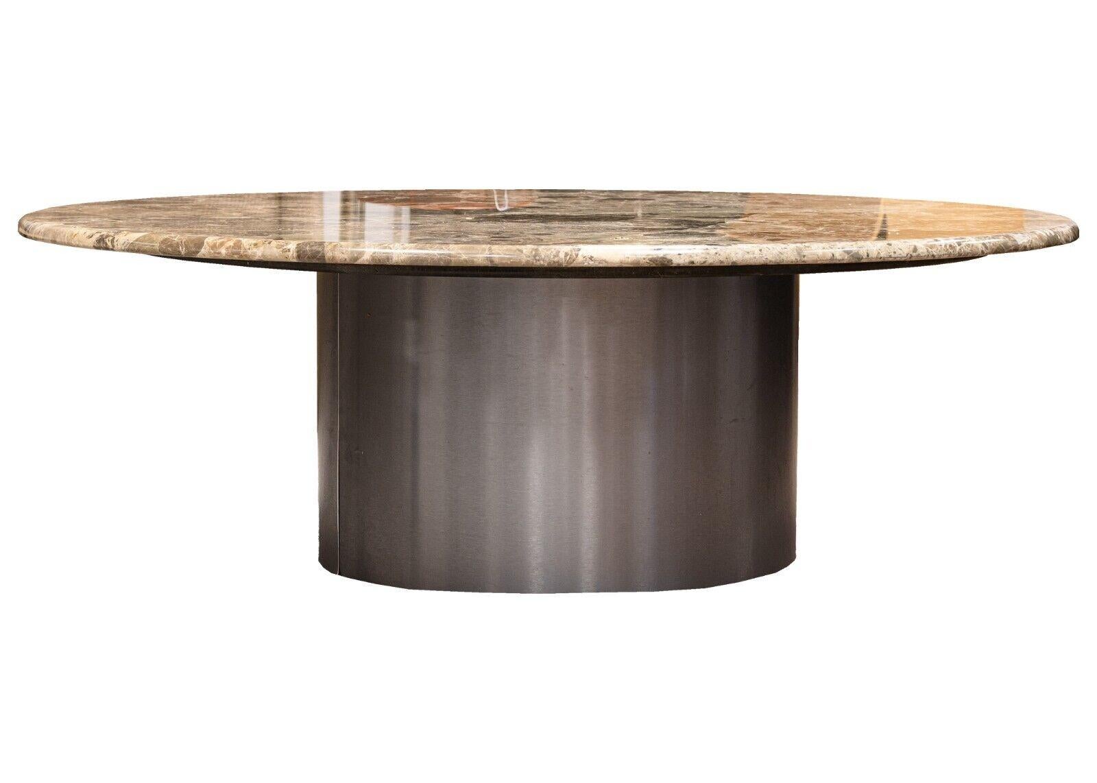 A round marble coffee table with a metal cylinder base. A spectacular contemporary modern coffee table. This large coffee table is constructed in three tiers; metal cylinder base, a wood spacer, and then a gorgeous sculpted piece of marble. This