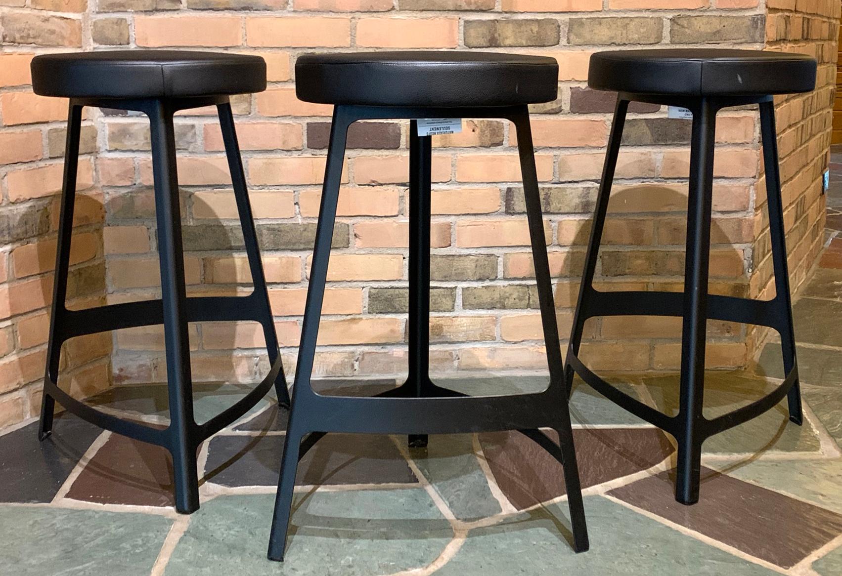 For your consideration is a terrific set of three, metal bar stools, with foot rests, by Sean Dix Factory. In excellent condition. The dimensions are 17