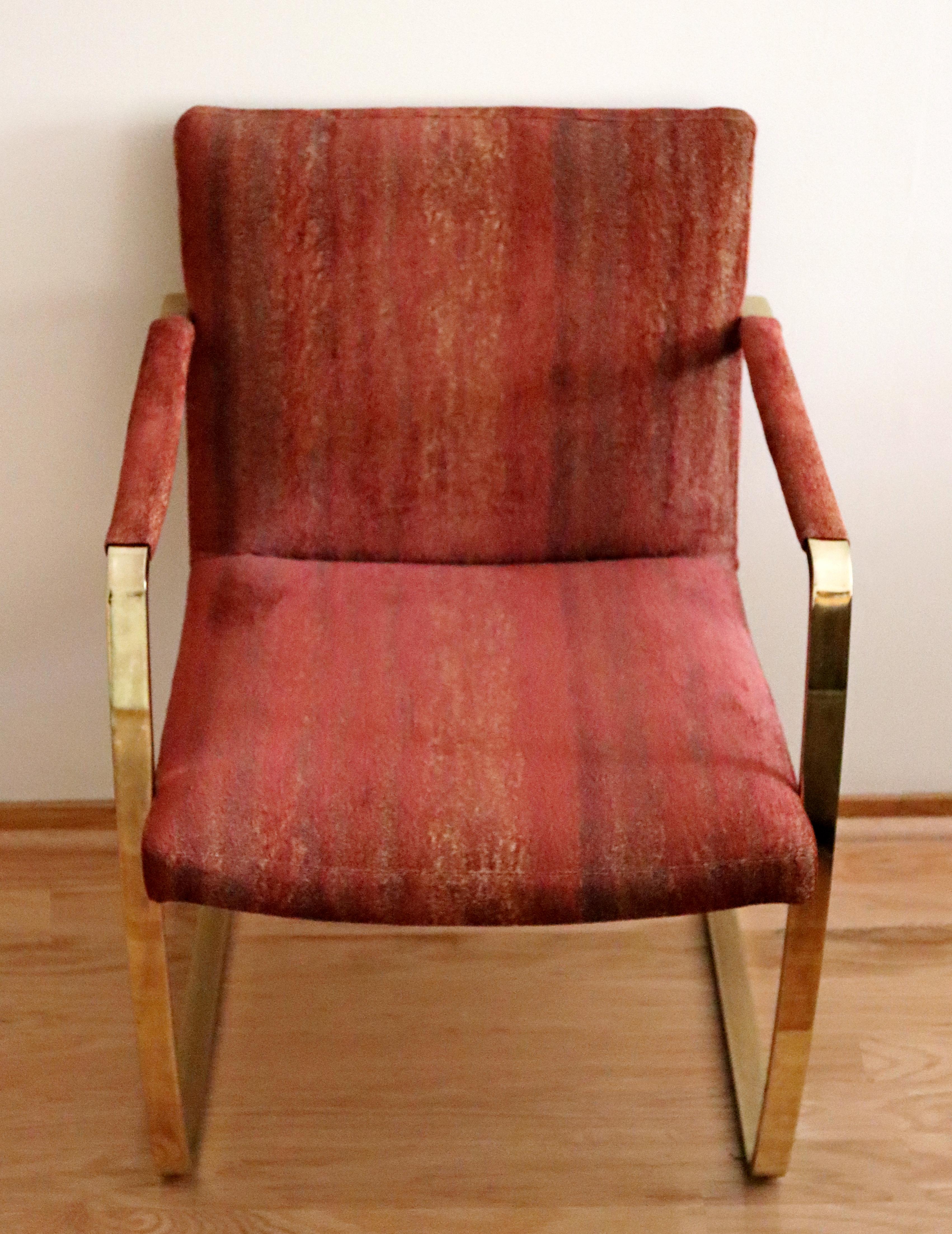 For your consideration is a ravishing set of four armchairs, made of cantilever brass and with red fabric upholstery and leather armrests, circa the 1980s. In very good vintage condition. The dimensions are 22.25