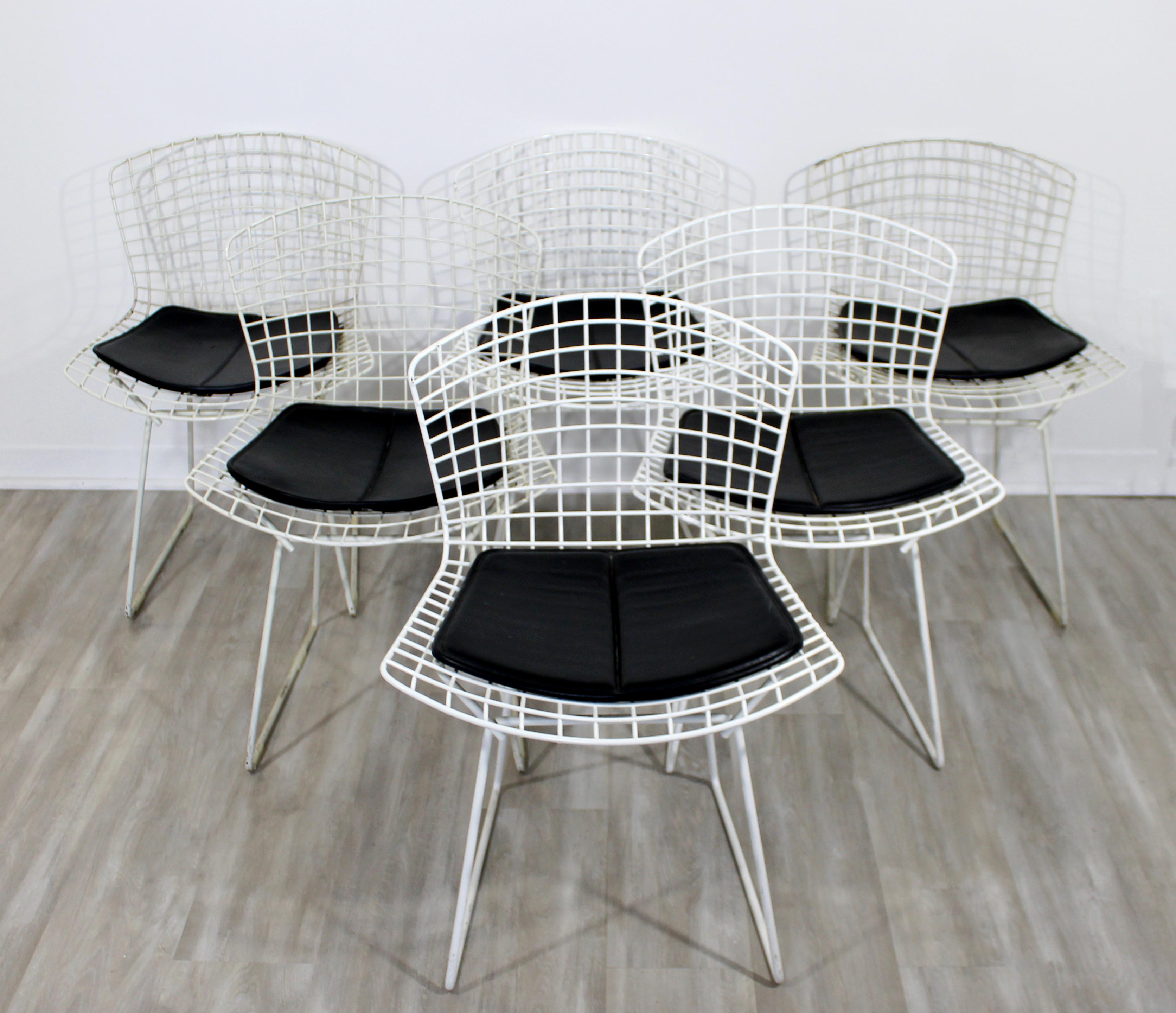 For your consideration is a fantastic set of six white side chairs, with Knoll tags, by Harry Bertoia. Three of the six are original, circa 1960s, and the other three are the 1980s. In very good vintage condition. The dimensions are 21