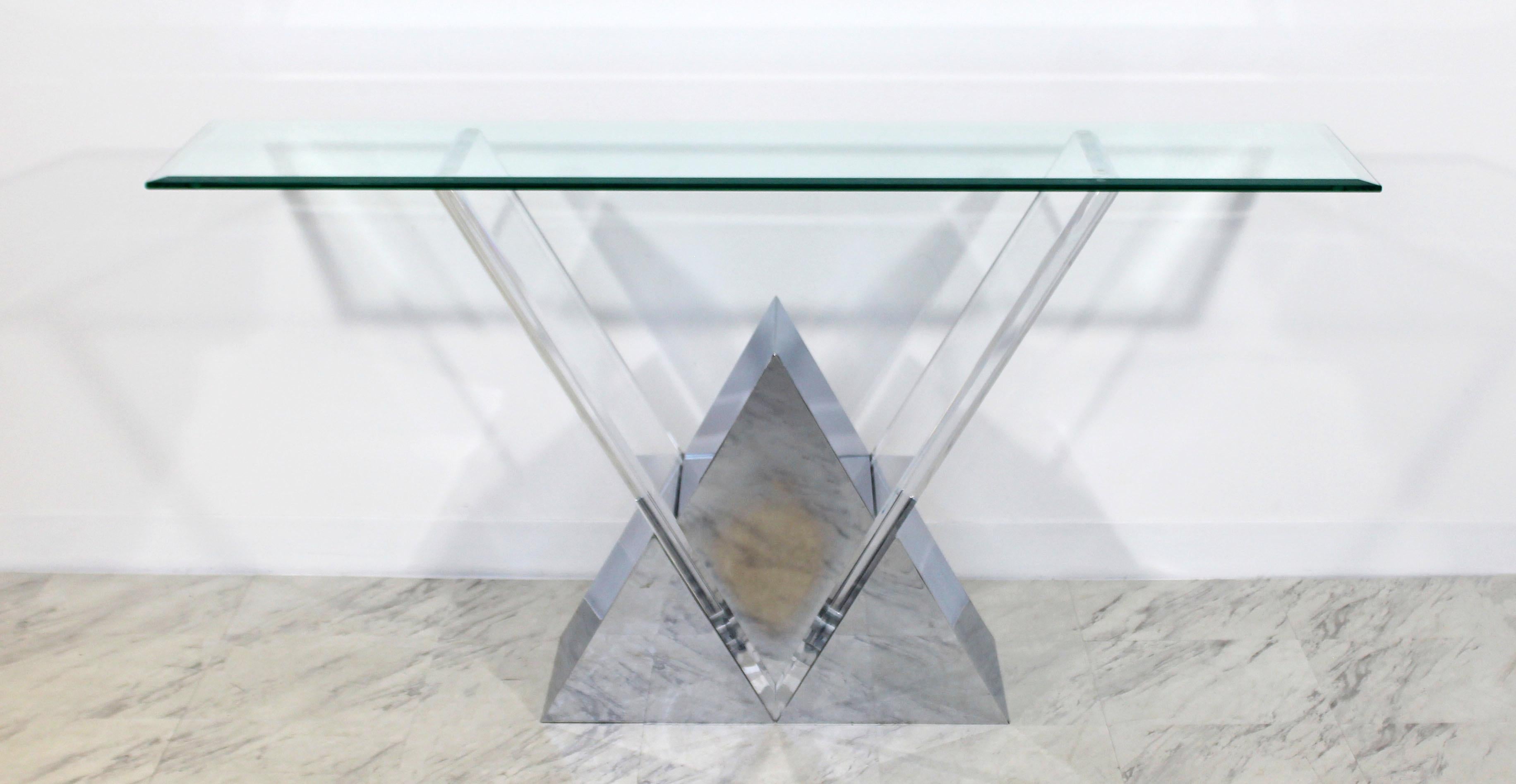 For your consideration is an absolutely stunning, chrome and Lucite console table, with a long glass top, by Shlomi Haziza, circa 1990s. In very good condition. The dimensions are 60