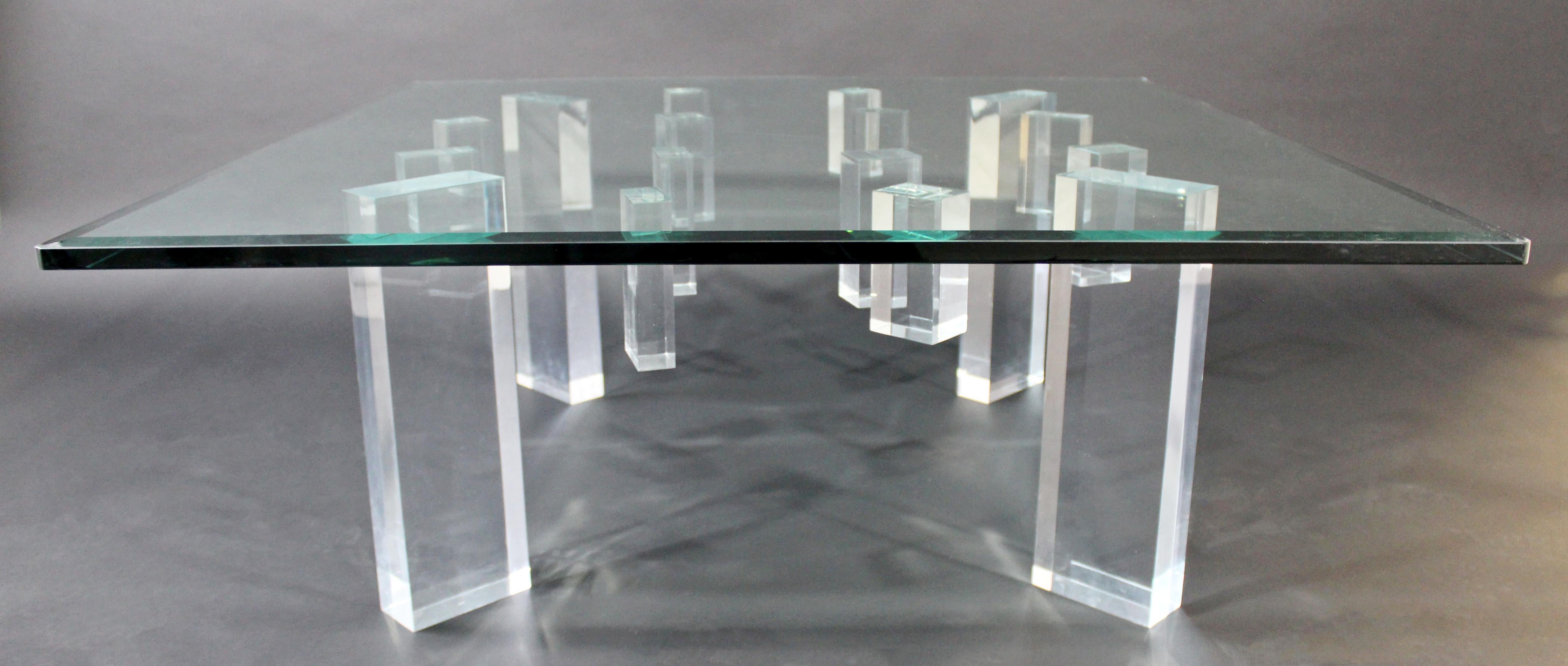 For your consideration is a spectacular, square glass topped coffee table, on Lucite acrylic legs, circa 1980s. In very good vintage condition. The dimensions are 42
