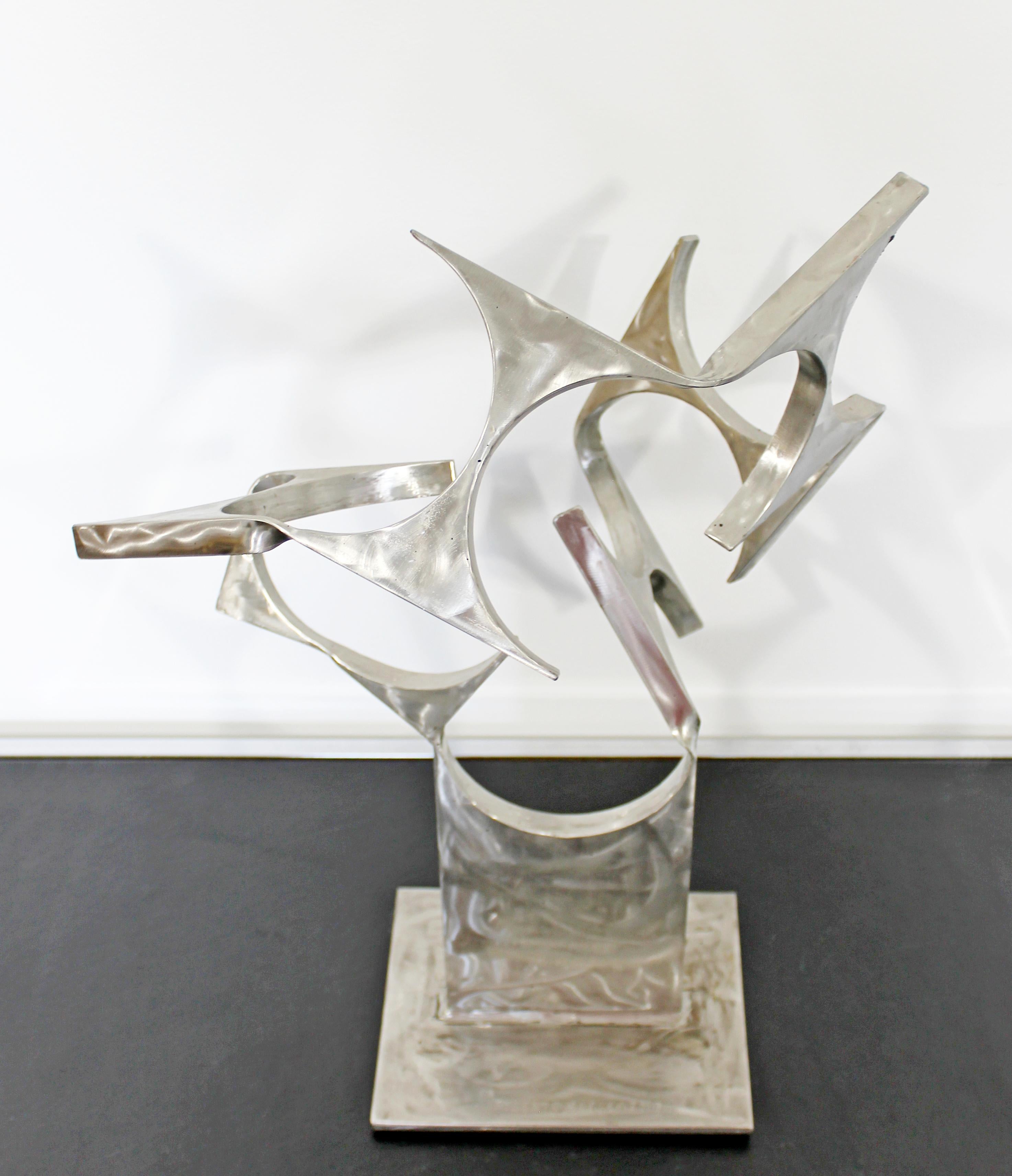 For your consideration is a modernist, abstract, stainless steel table sculpture, signed Robert D. Hansen, dated 2016. In excellent condition. The dimensions are 15