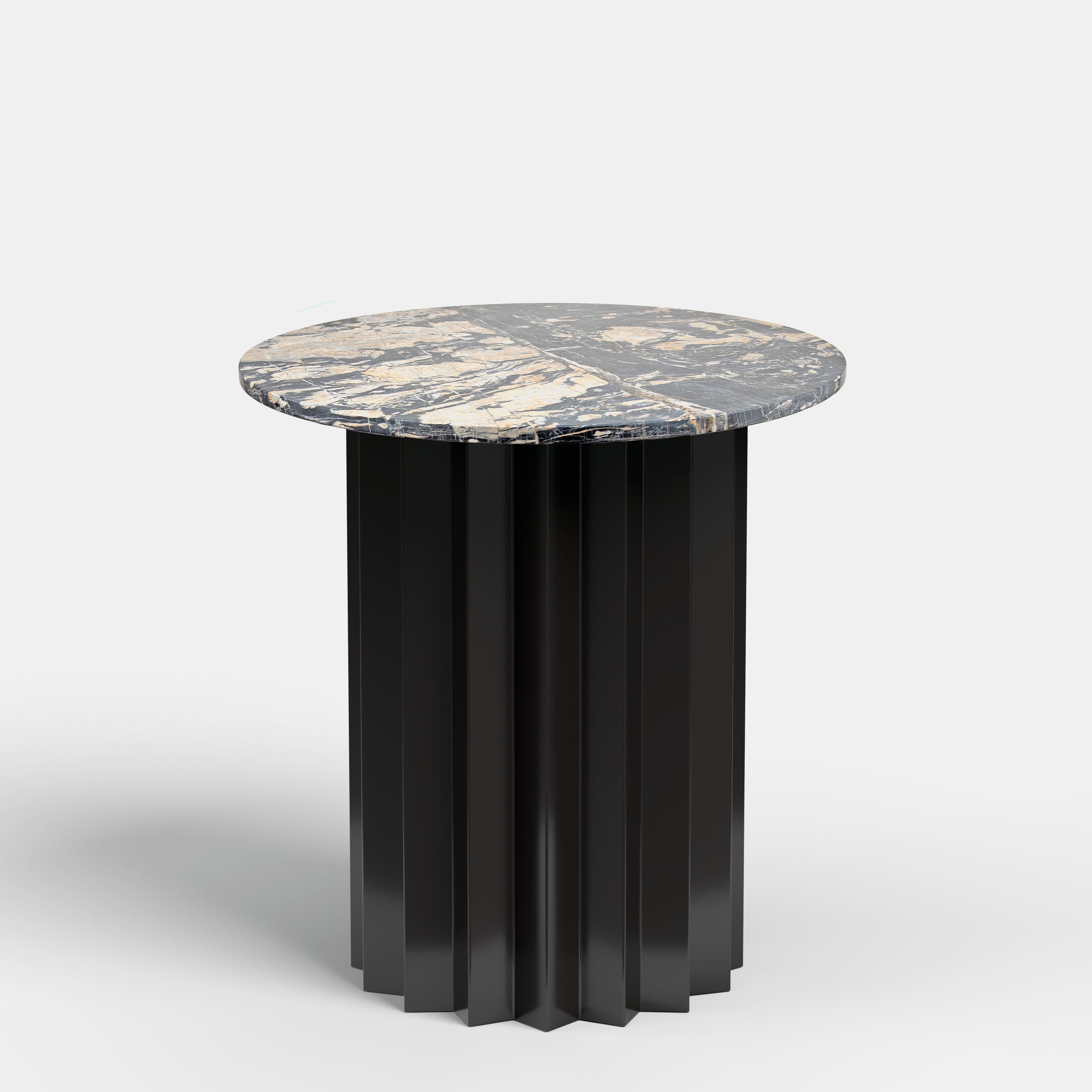 Volume is a collection of dining and side tables designed by DAY Studio in their unique simple and playful language. The powder coated metal base is completed with a table top selected from a distinguished choice of material and finish