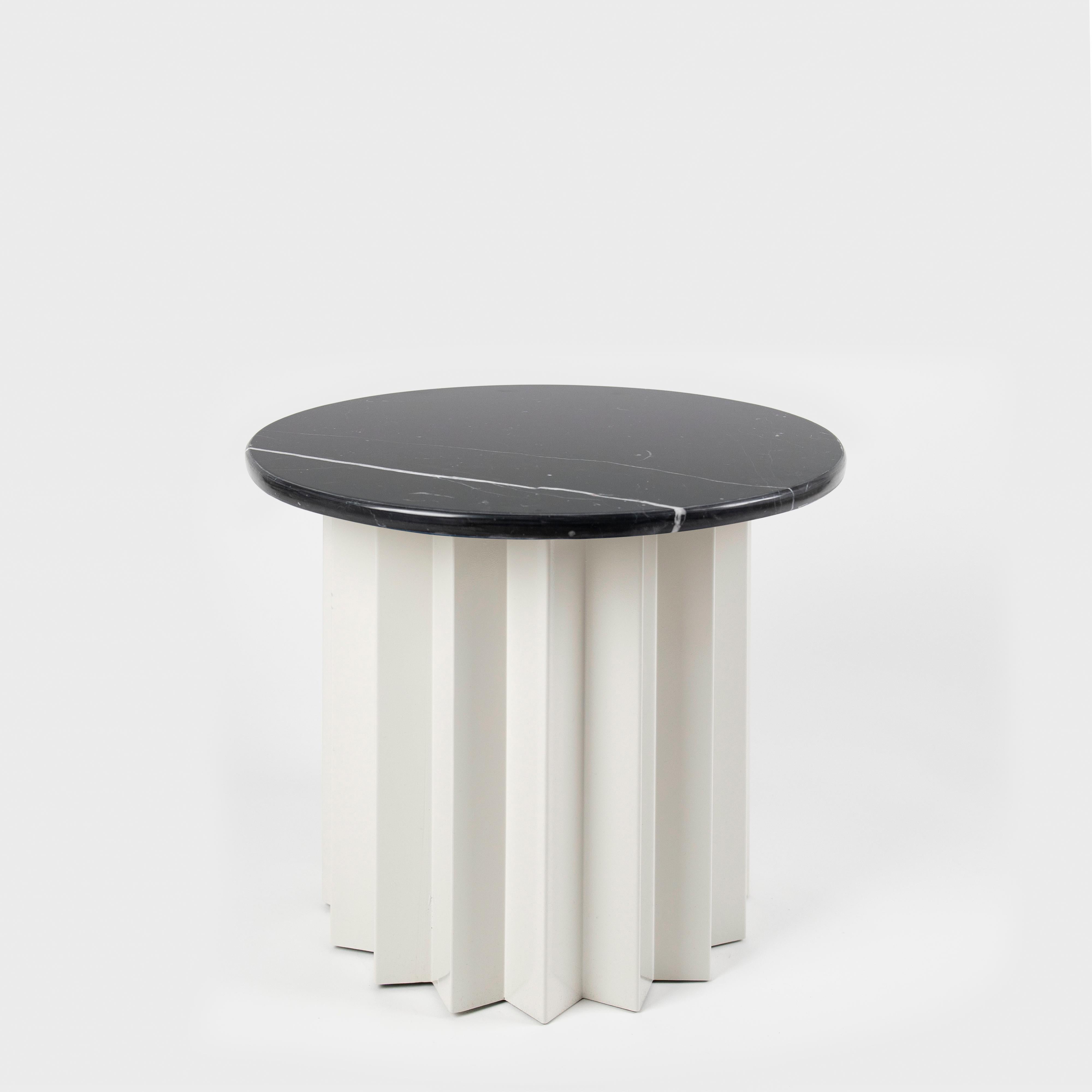 Volume is a collection of dining and side tables designed by DAY Studio in their unique simple and playful language. The powder coated metal base is completed with a table top selected from a distinguished choice of material and finish options.

An