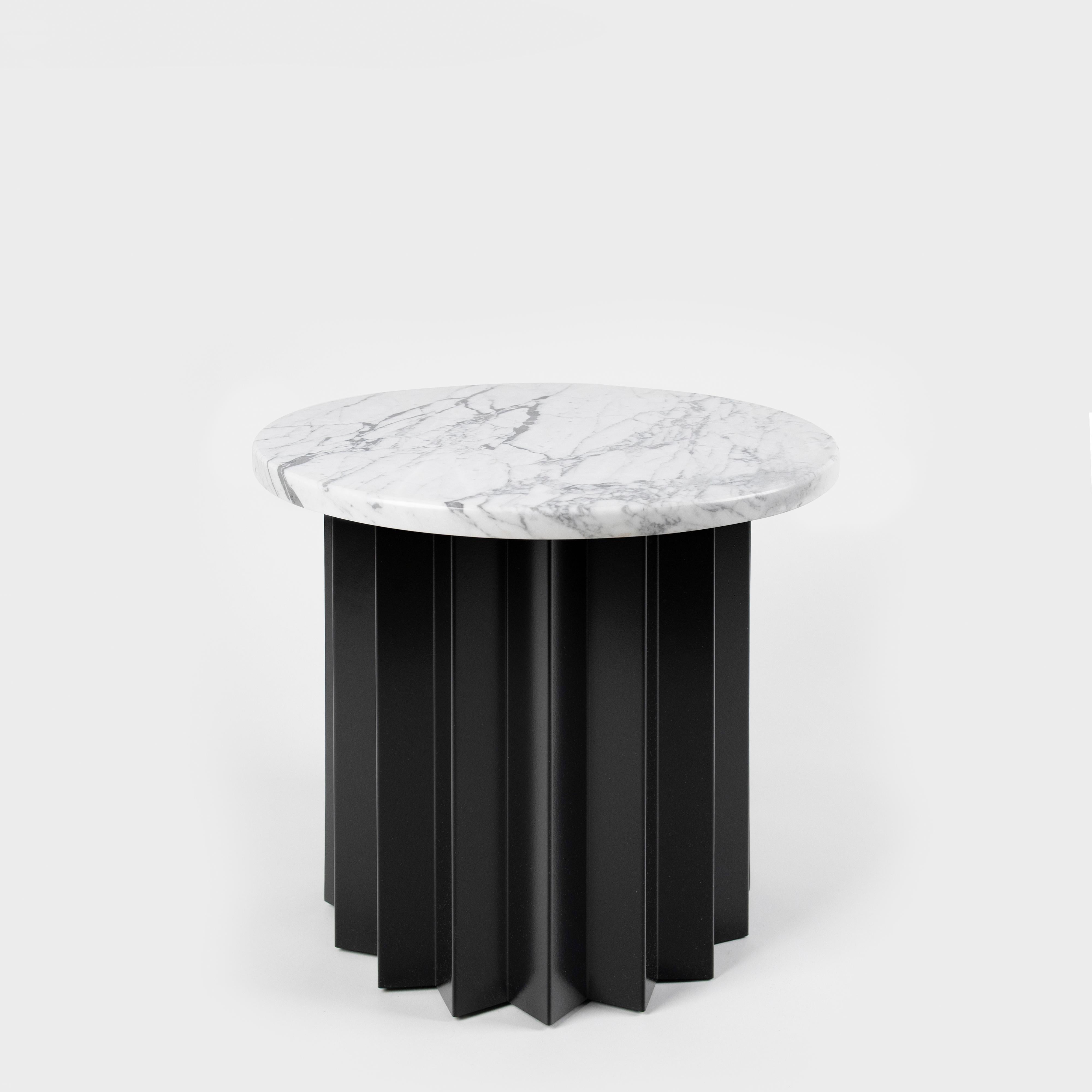 Volume is a collection of dining and side tables designed by DAY Studio in their unique simple and playful language. The powder coated metal base is completed with a table top selected from a distinguished choice of material and finish