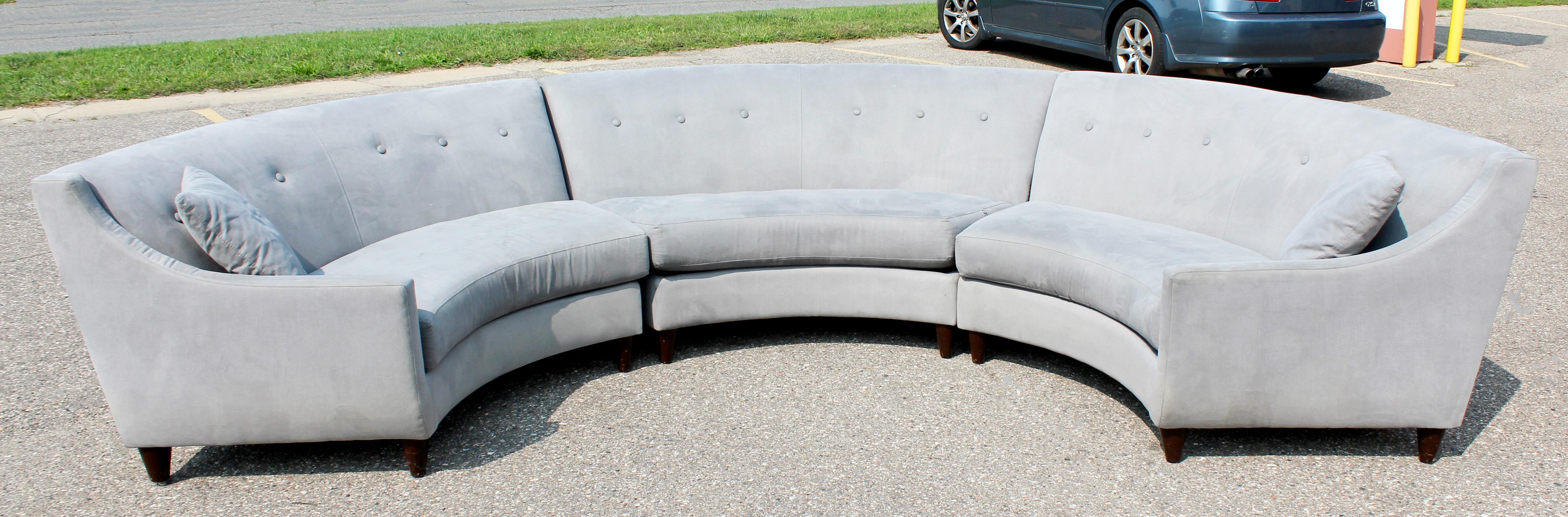 For your consideration is a magnificent, three-piece, curved, high backed sectional sofa in a dove grey upholstery, on walnut legs, in the Dunbar style. In excellent condition. The dimensions of each piece are 76