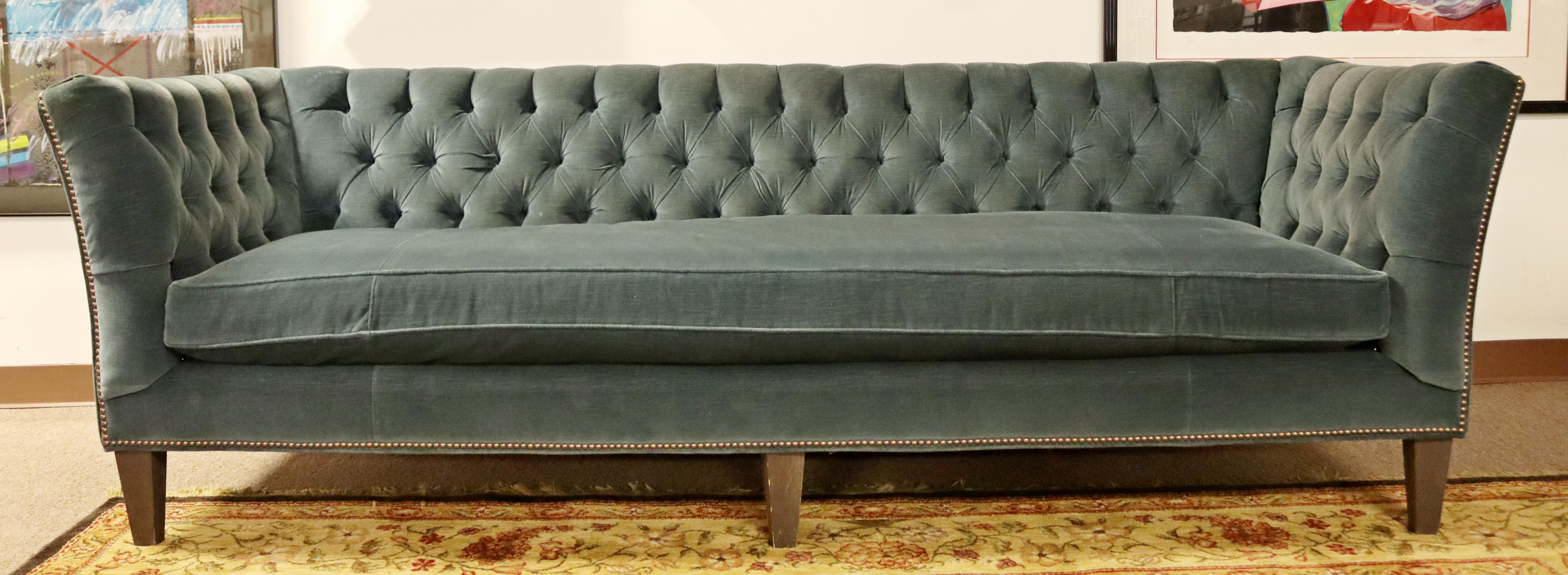 For your consideration is a fantastic, tufted sofa, with a blue velvet upholstery, in the style of Dunbar, by Arhaus. In good condition. The dimensions are 97
