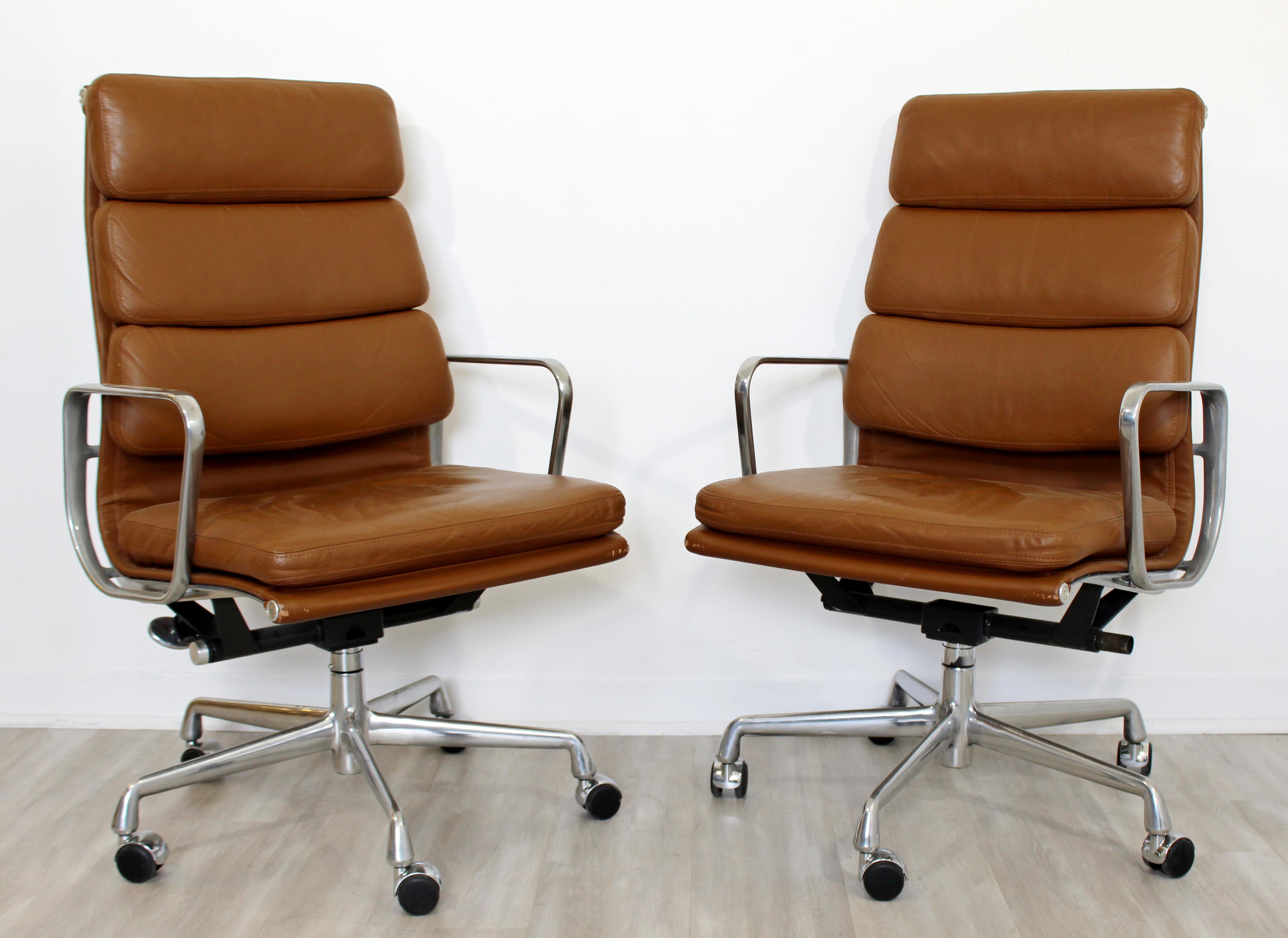 For your consideration is a magnificent, soft pad, rolling office chair, upholstered in brown or tan leather, by Eames for Herman Miller, circa 2001. In excellent condition. The dimensions are 22