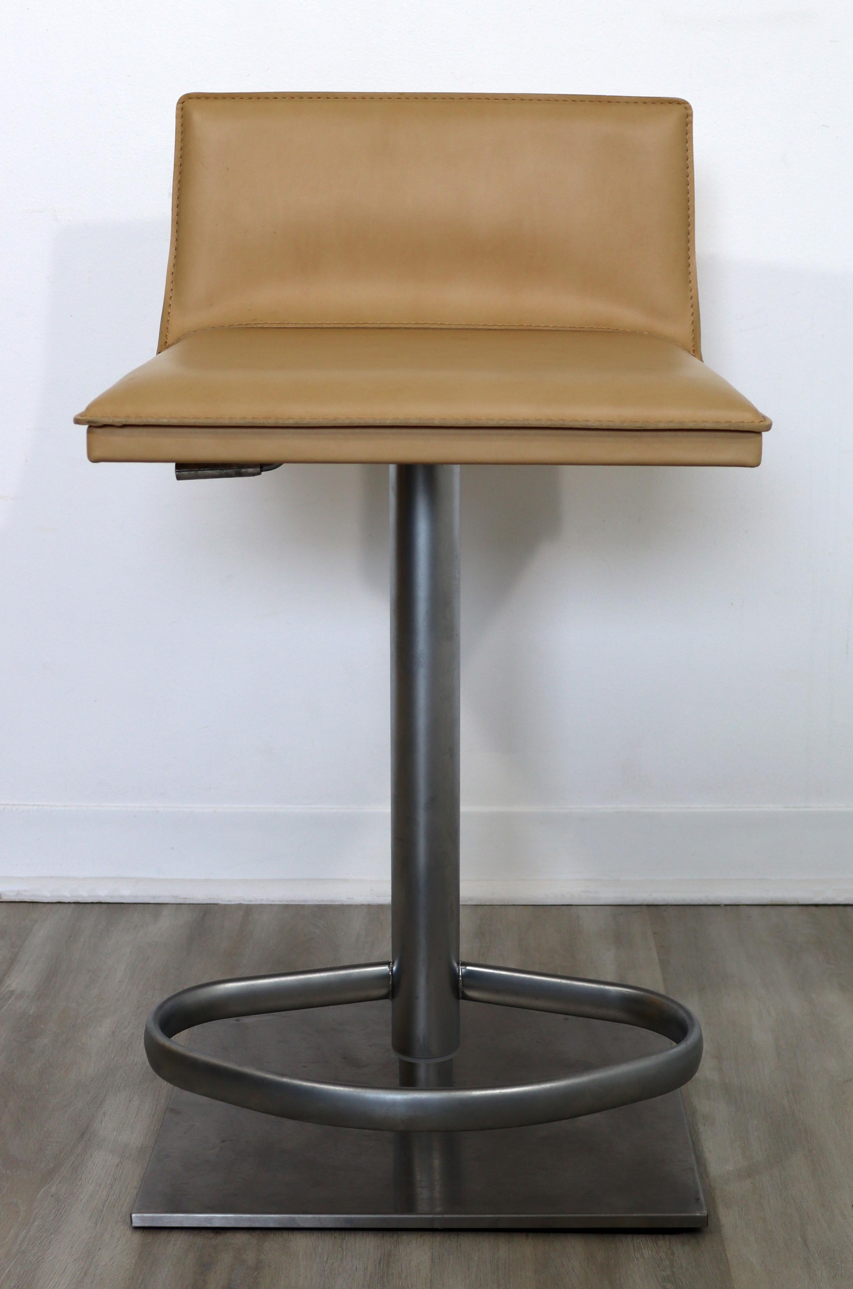 For your consideration is a brushed aluminum, bar or counter stool, upholstered in beige leather, handmade in Italy, by Frag. In excellent condition. The dimensions are 16.5