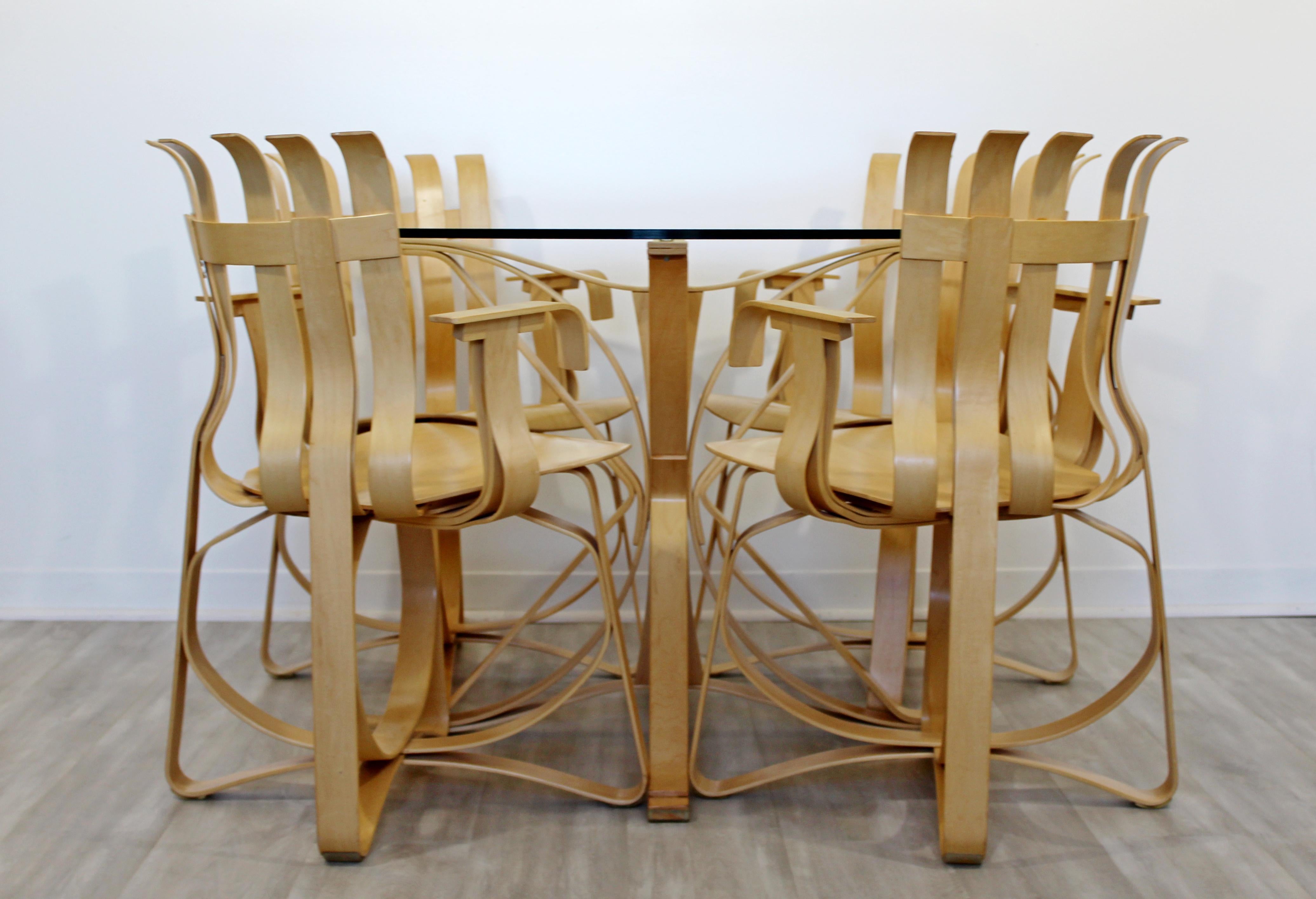 For your consideration is an extravagantly designed dinette set, including what is called a face off table and four hat trick armchairs, by Frank Gehry for Knoll, made in America, circa 2000. In excellent condition. The dimensions of the table are