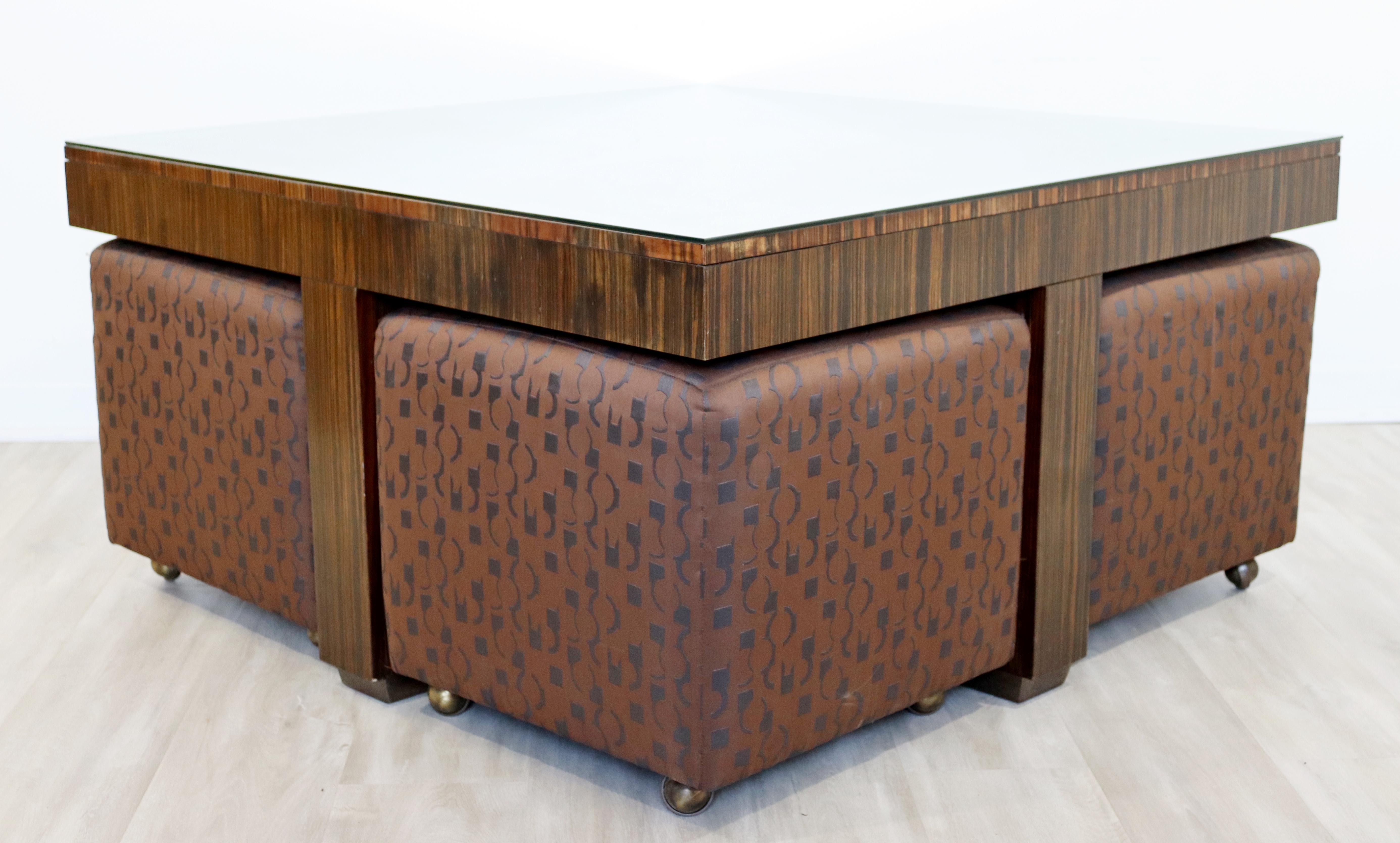 For your consideration is a dazzling, zebra wood coffee table, with a glass top and four rolling stools that fit underneath, by Henredon, circa the 1990s. In excellent vintage condition. The dimensions of the table are 44