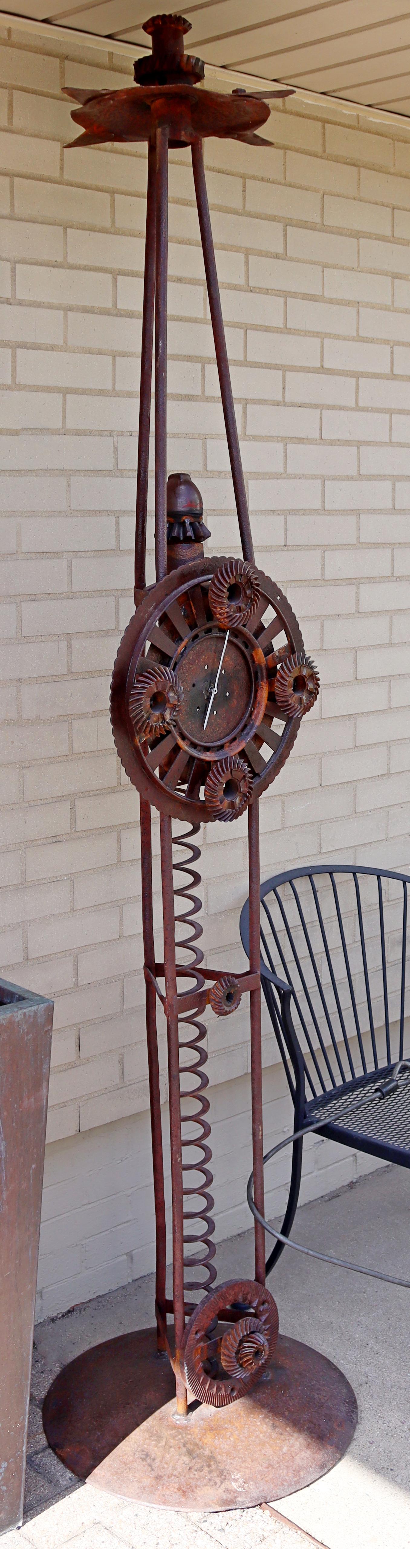 For your consideration is an incredible, abstract, outdoor floor sculpture, with a working clock. In excellent condition. The dimensions are 20