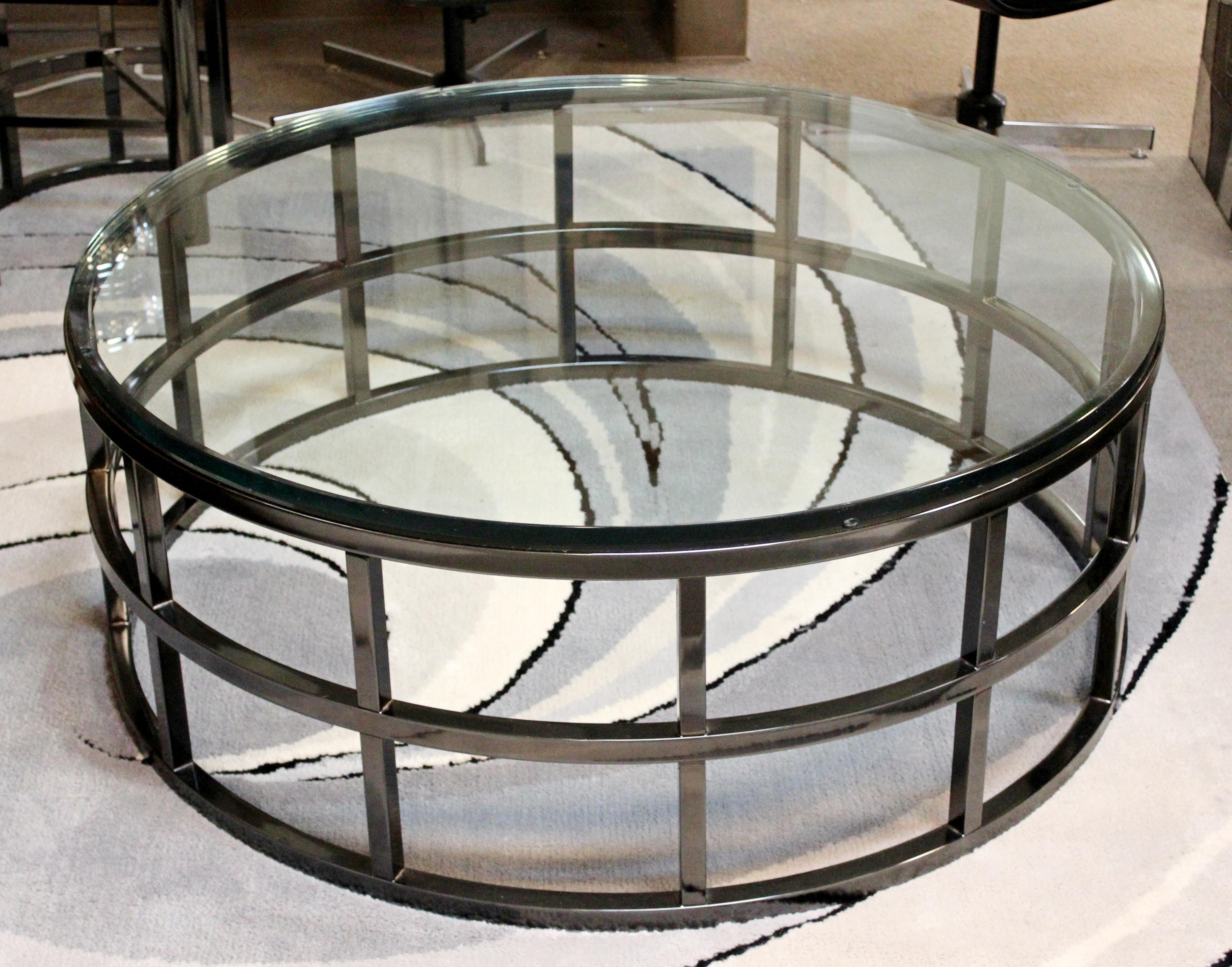 For your consideration is a marvellous, round coffee table with a glass top on a gunmetal base by Brueton, circa 1980s. Amazing piece of round green edge glass that is 3/4