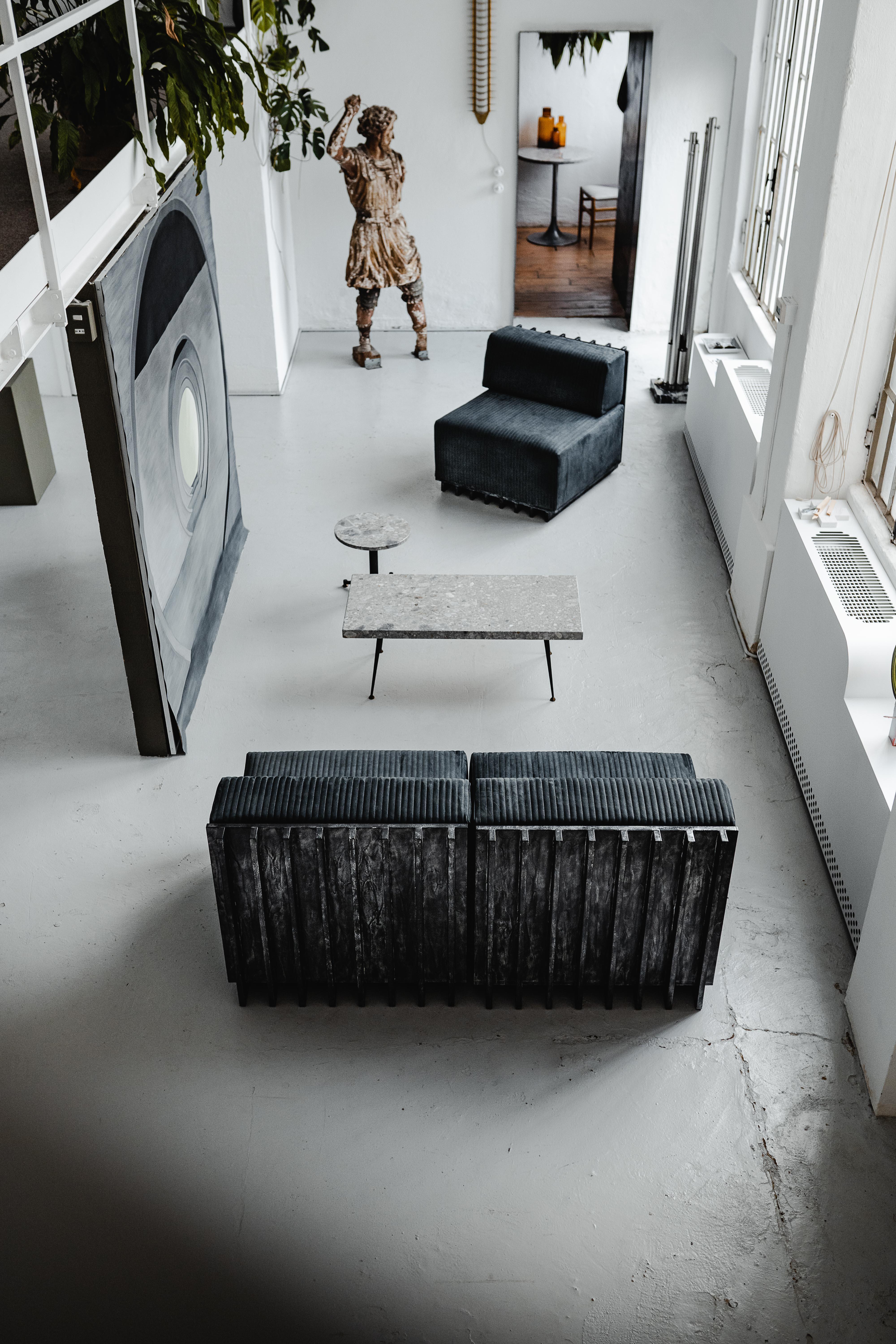 Modular Sofa - Armchair / Armchairs in black metallic Patina 

Technical and tactile like an air-cooled engine, Lamè melts the hardware world of engines mechanics with the softness of a seat. The foamy grey leather welcomes you to chill-out while